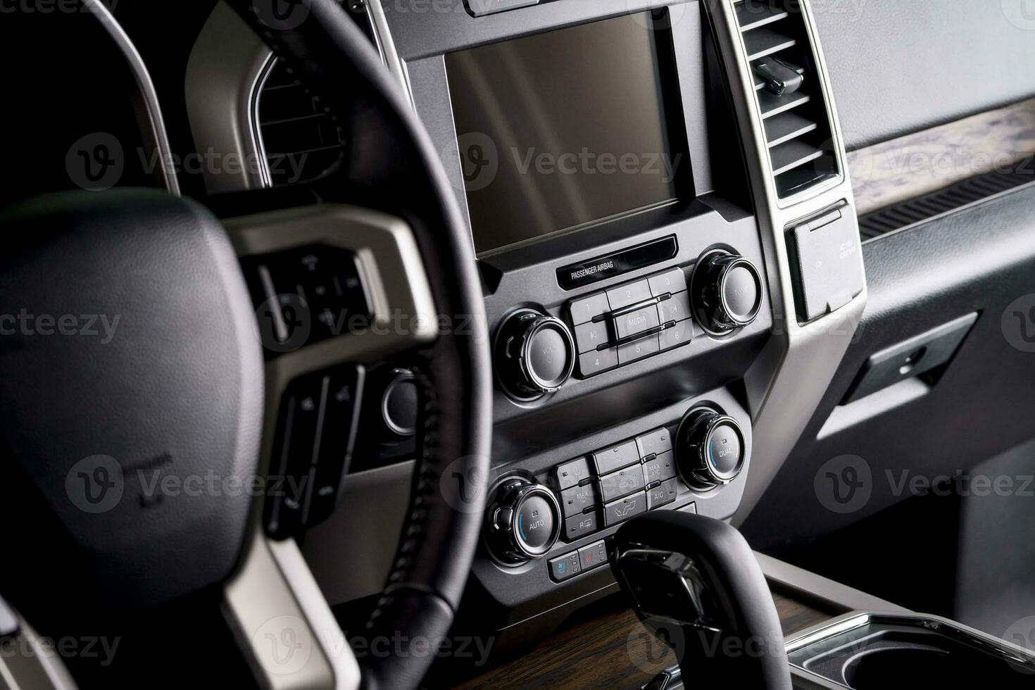 Luxury car steering wheel and dashboard with multimedia screen, comfortable interior for the driver photo