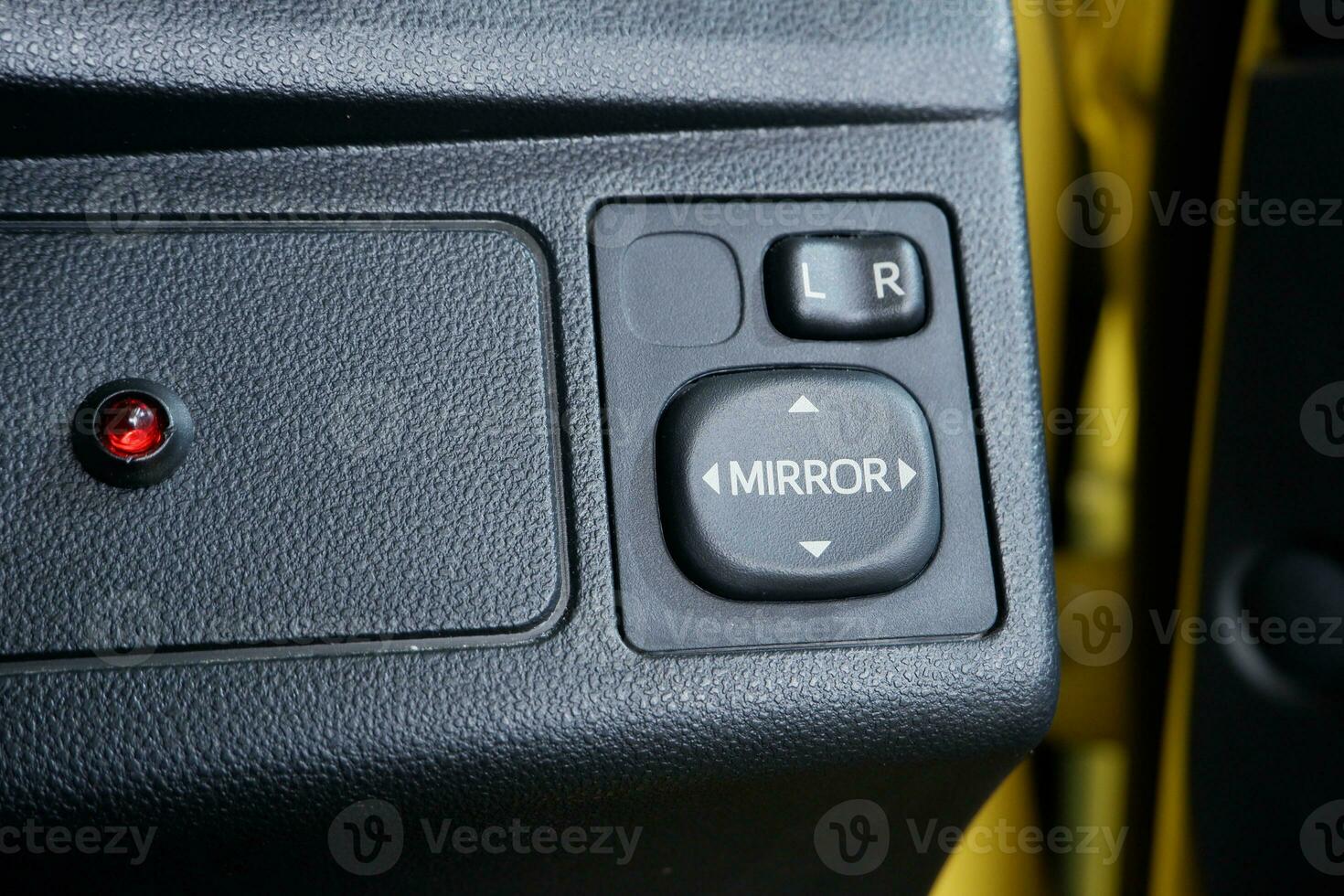 switch button to adjust the direction of the mirror on the car dashboard photo