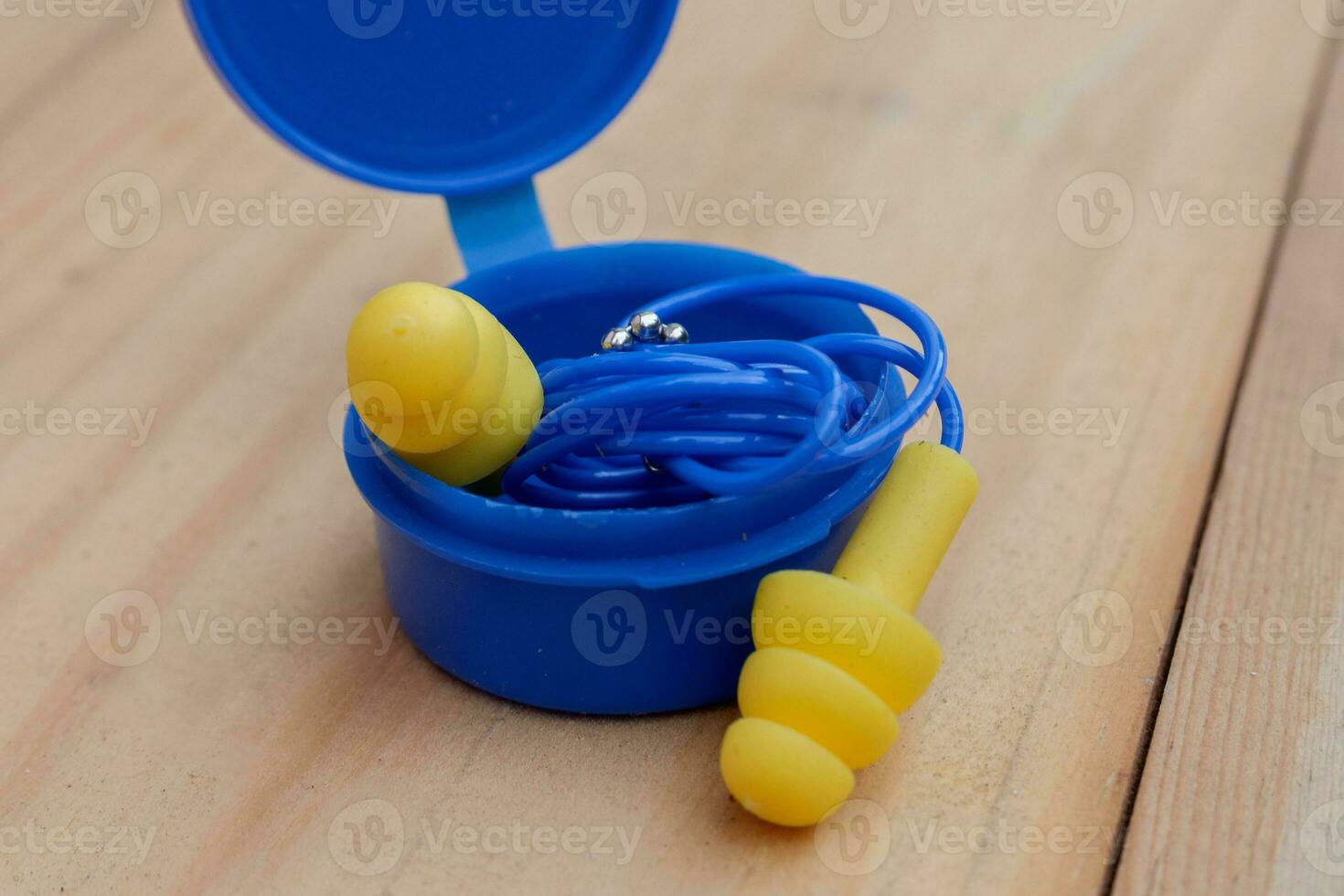 selective focus on yellow silicone ear plugs with ear plug storage tubes photo