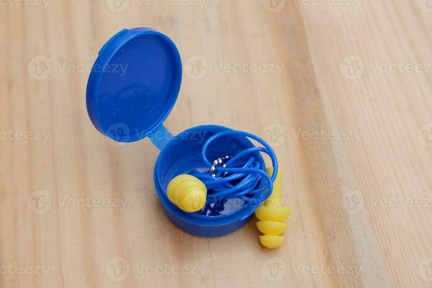 selective focus on yellow silicone ear plugs with ear plug storage tubes photo