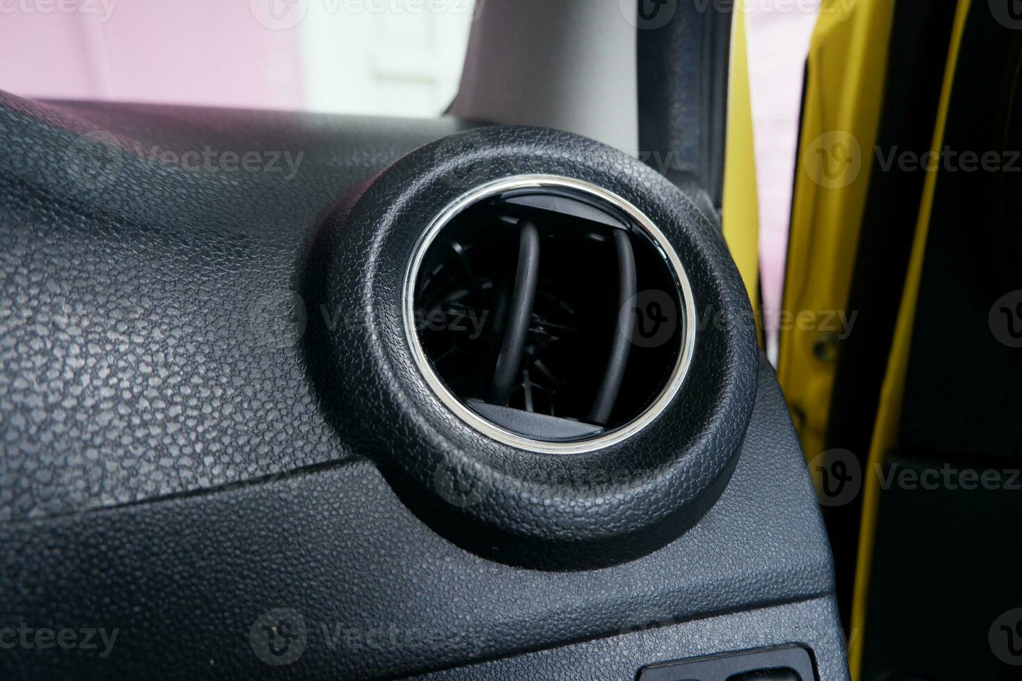 ventilation on the dashboard of a car with a opened grille