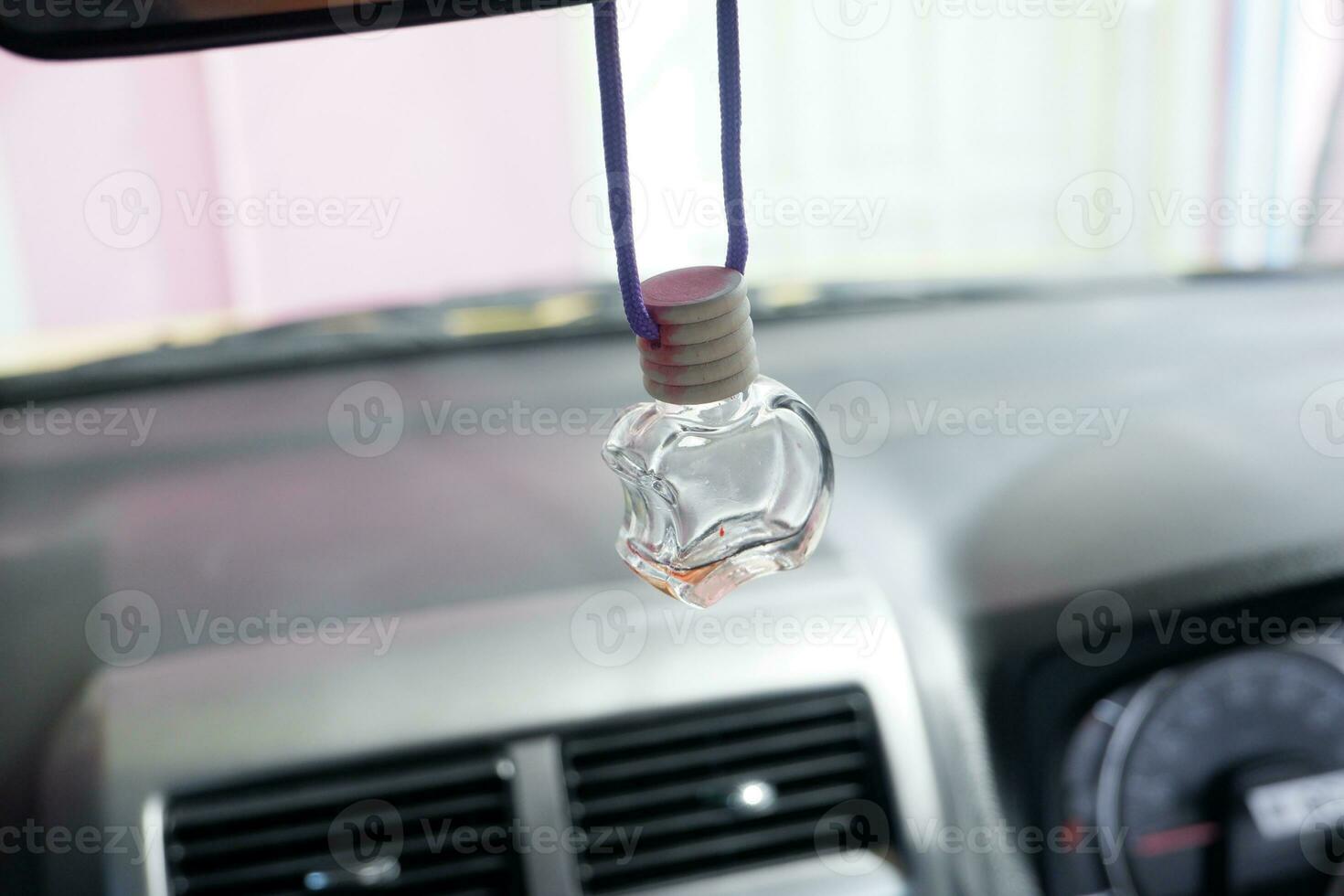 selective focus on empty car air freshener bottle hanging from rope