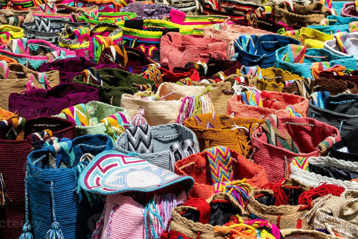 Street selling in Bogota of traditional bags hand knitted by women of the Wayuu community in Colombia called mochilas photo