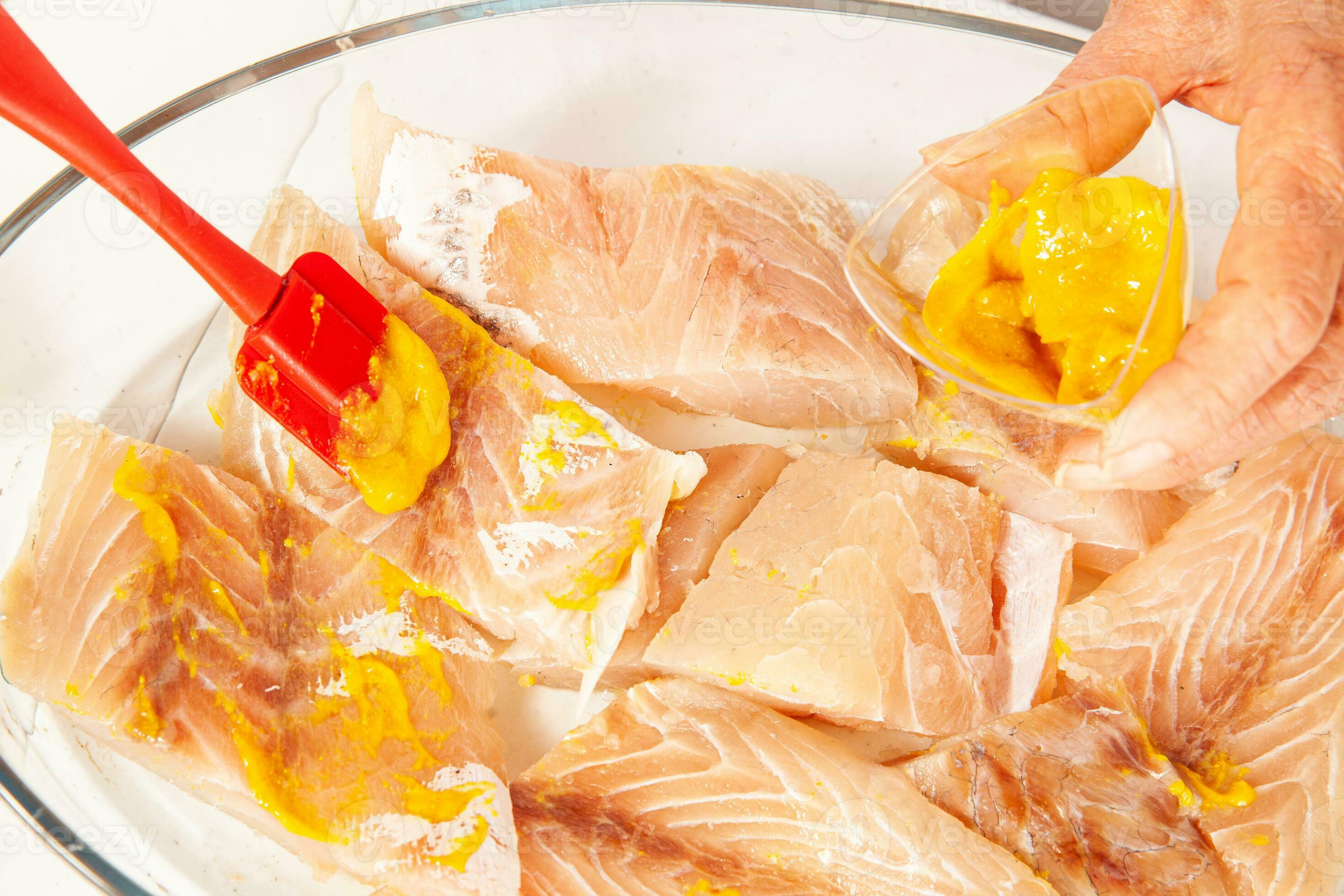 Fish marinade preparation steps. Spreading the fish with mustard 26364804 Stock Photo at Vecteezy