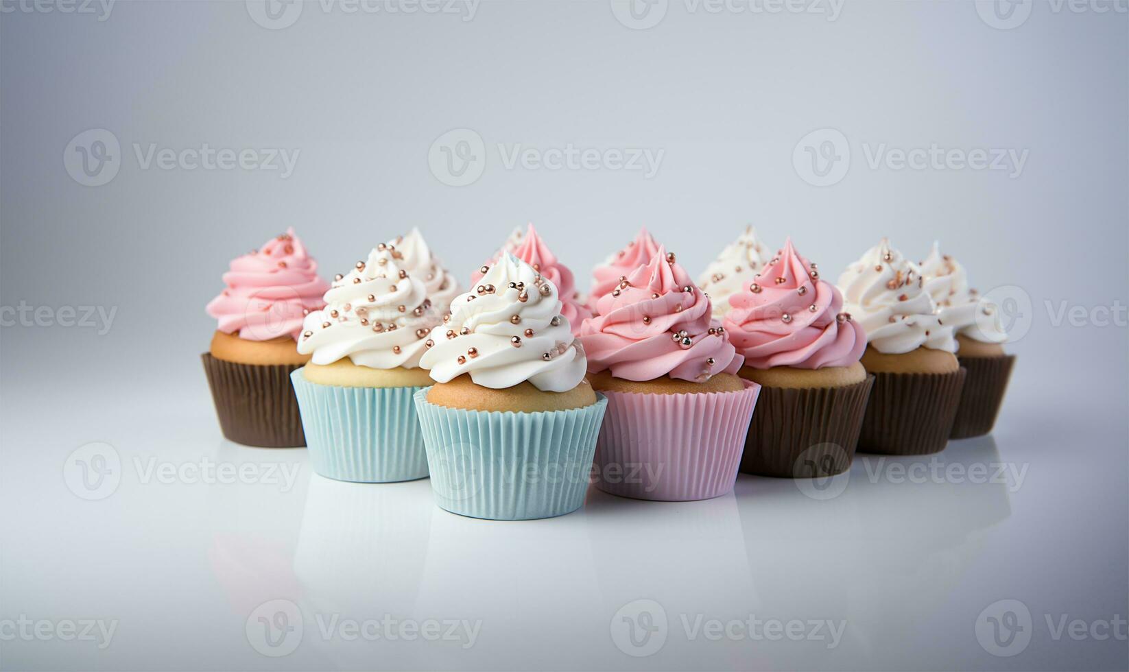 Cupcakes with blue and pink decoration on white background, close up view. AI Generated photo