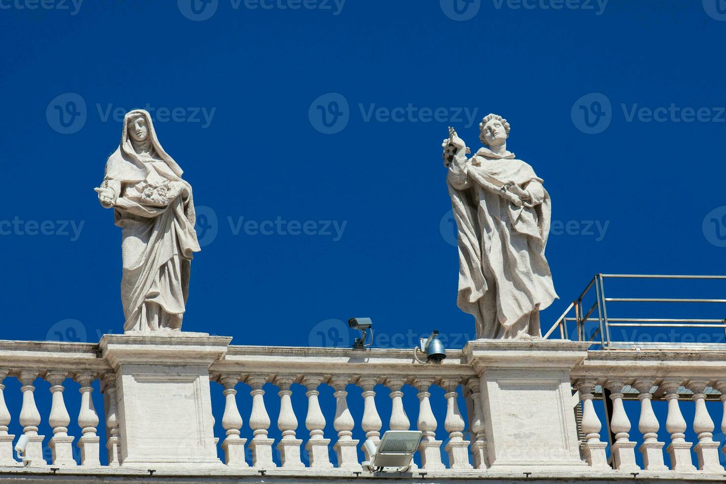 Detail of the statues of saints that crown the colonnades of St. Peter Square built on 1667 on the Vatican City photo