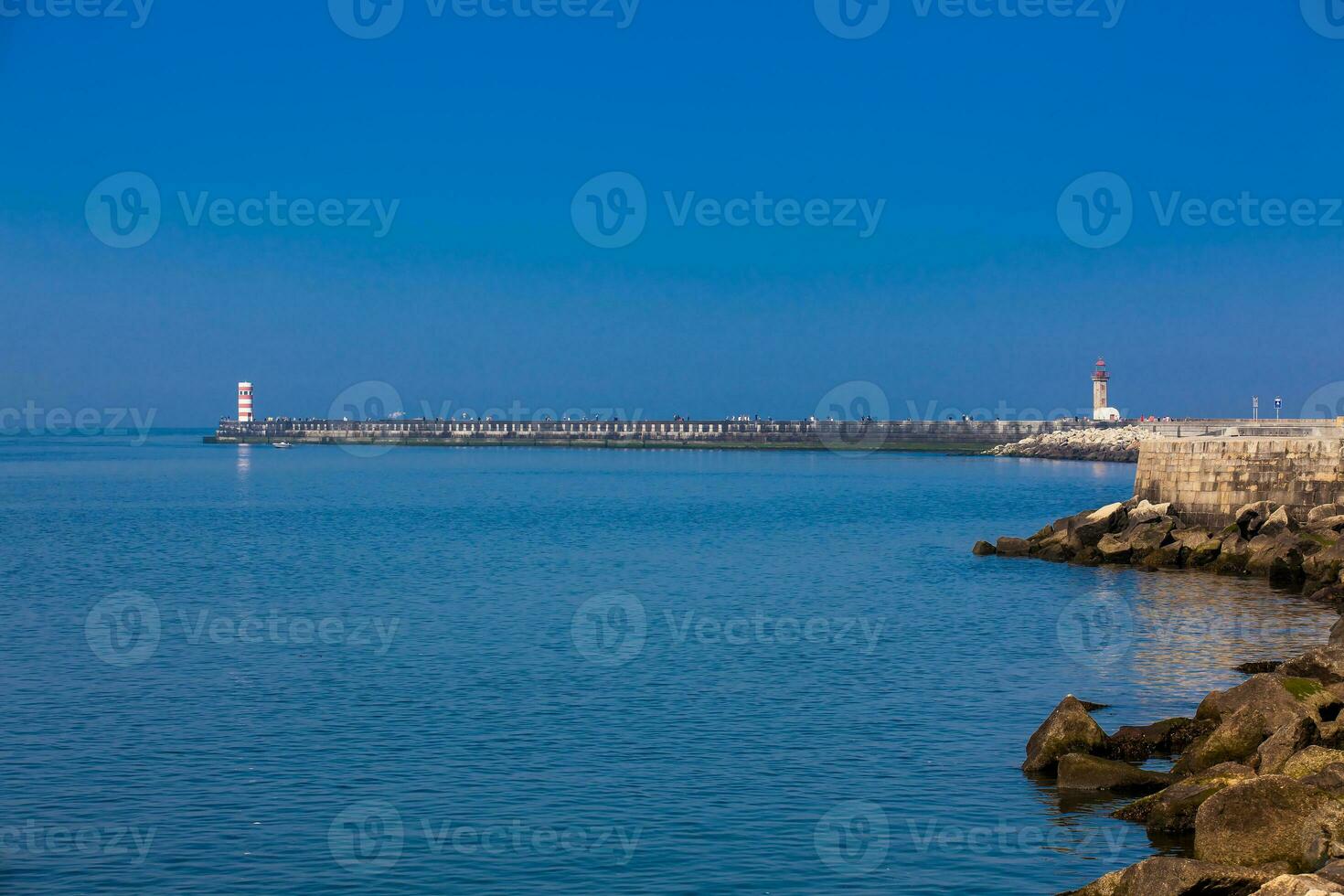 Lighthouses at the beautiful Porto coast near the Douro river mouth in a sunny early spring day photo