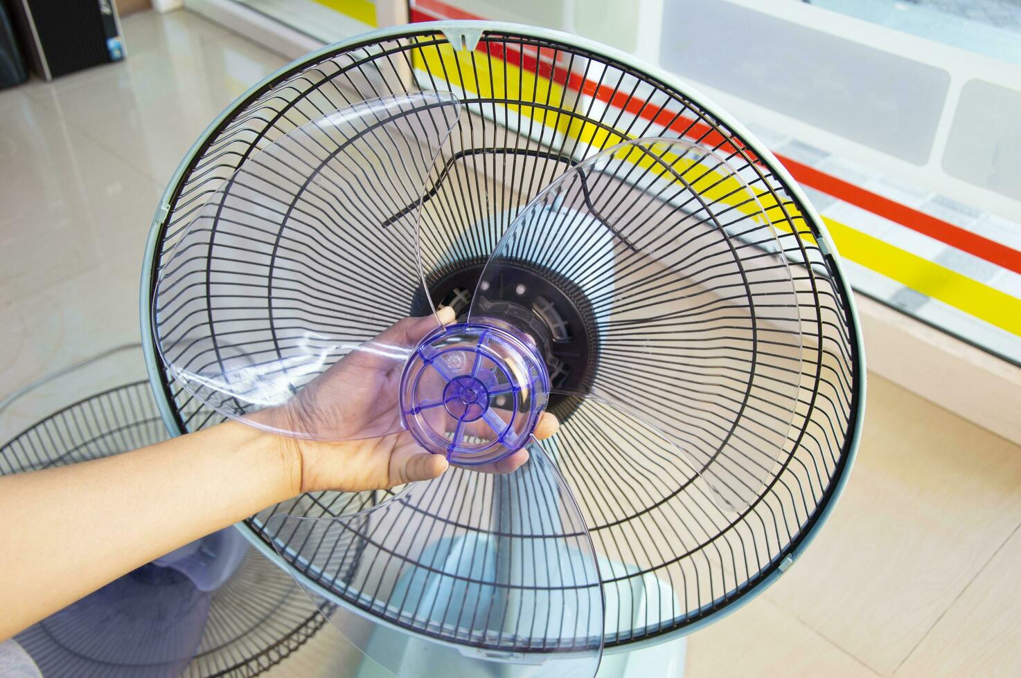 Technician repairing fan, replacing impeller photo