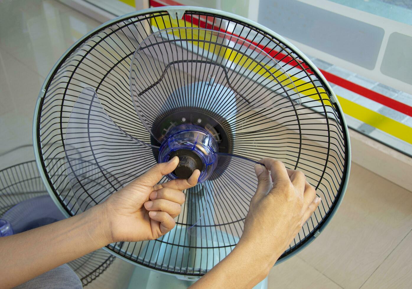 Technician repairing fan, replacing impeller photo