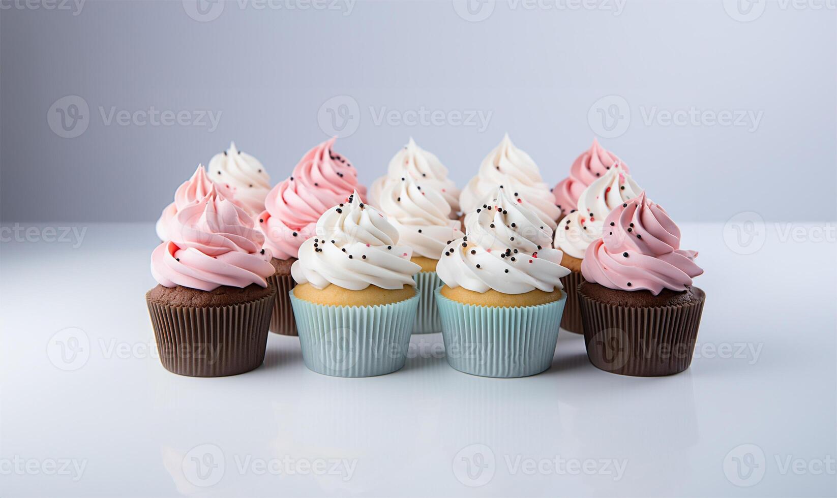 Cupcakes with blue and pink decoration on white background, close up view. AI Generated photo