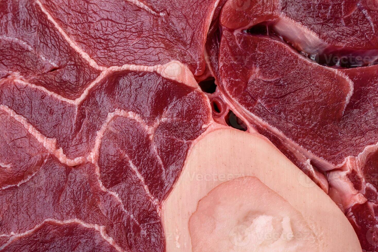 Fresh raw beef steak with bone or ossobuco with salt, spices and herbs photo