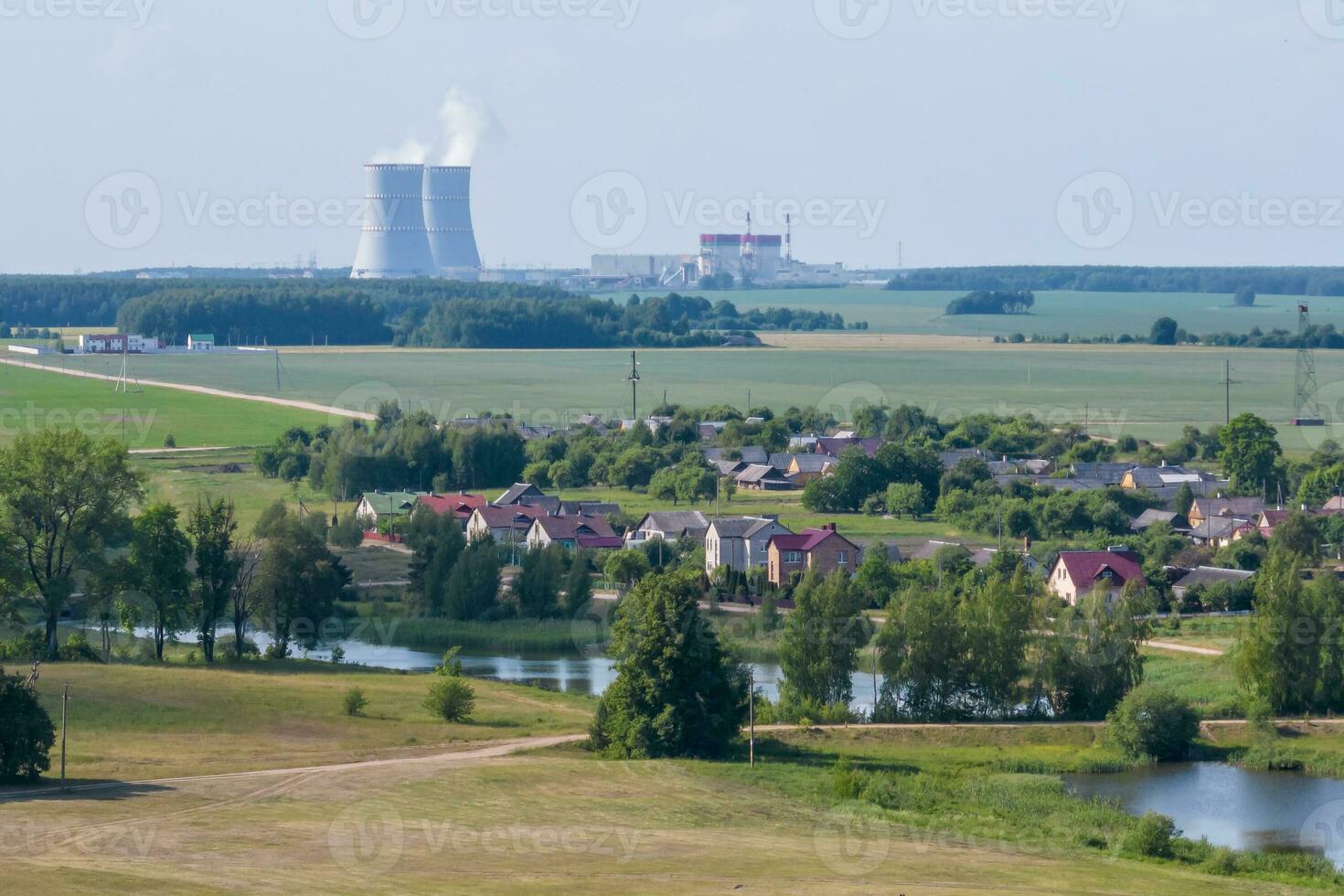 Cooling towers of nuclear power plant against the blue sky photo