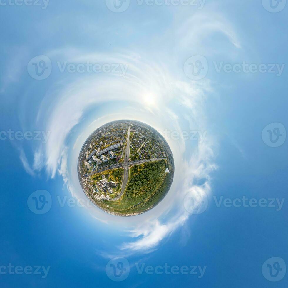 tiny planet in sky with clouds overlooking old town, urban development, historic buildings and crossroads. Transformation of spherical 360 panorama in abstract aerial view. photo