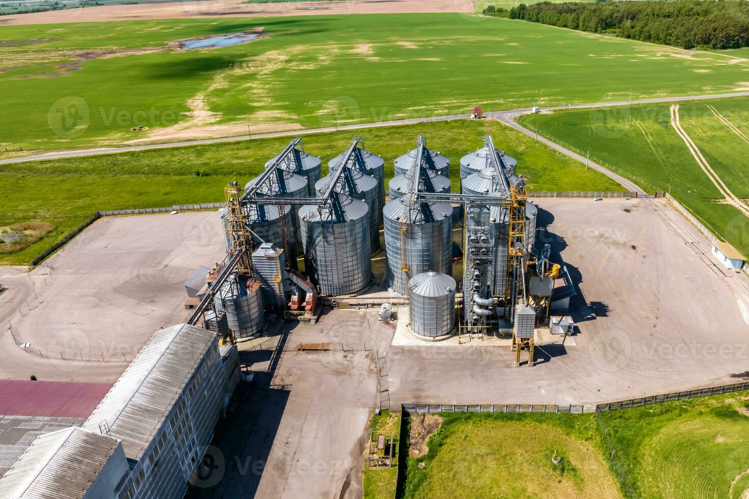 aerial panoramic view on agro-industrial complex with silos and grain drying line for drying cleaning and storage of cereal crops photo