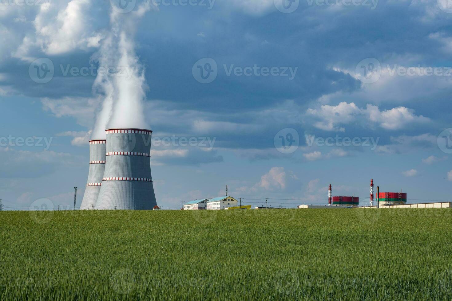 Cooling towers of nuclear power plant against the blue sky photo