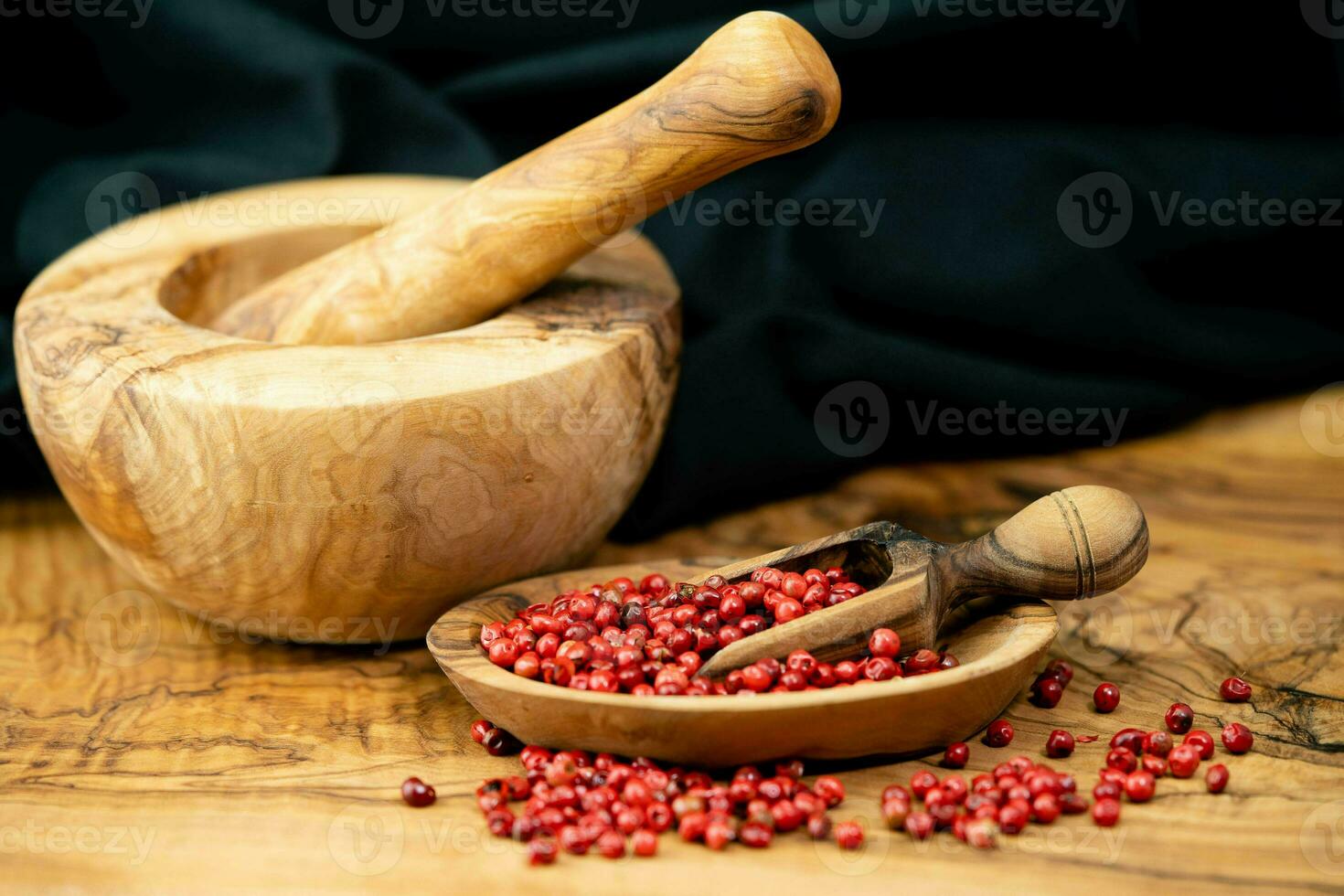 Red Pepper from the brazilian Schinus Terebinthifolia Tree on olive wood photo