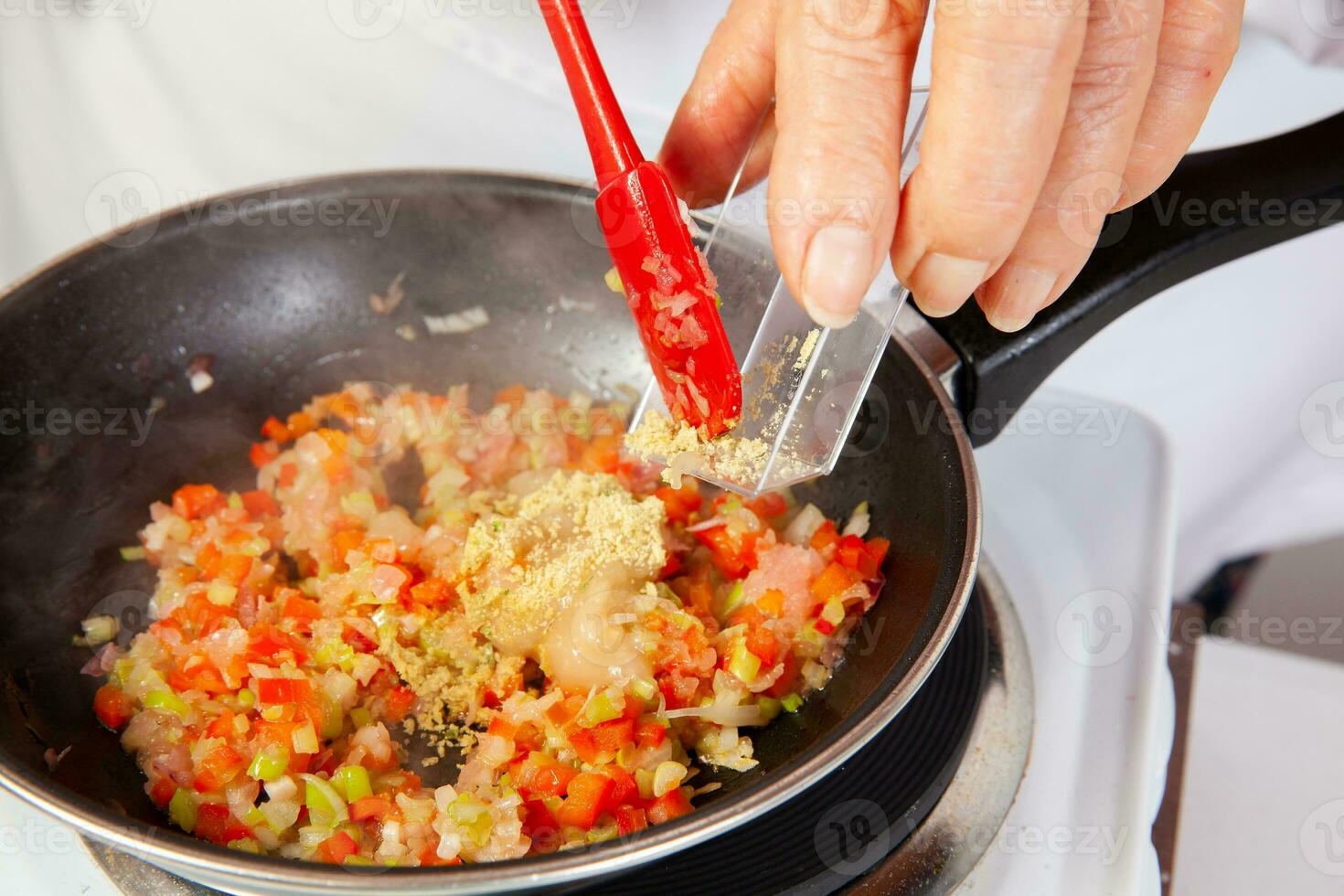 Preparation of the traditional Colombian hogao or criollo sauce made of onion, tomato, peppers and cilantro. Salsa criolla photo