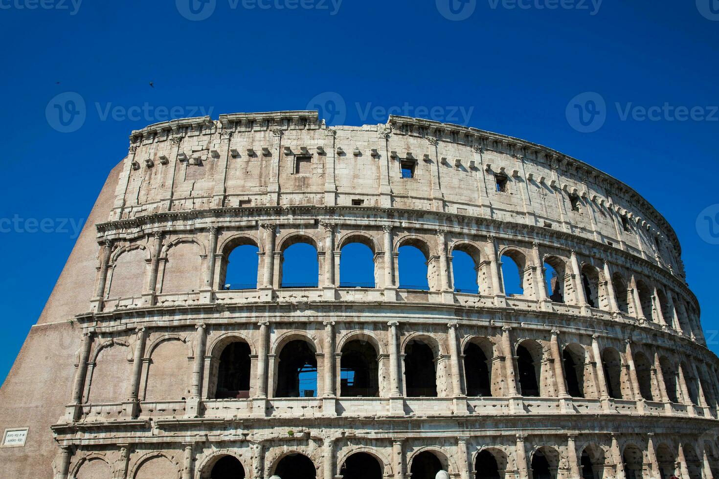 Detail of the famous Colosseum or Coliseum also known as the Flavian Amphitheatre in the centre of the city of Rome photo