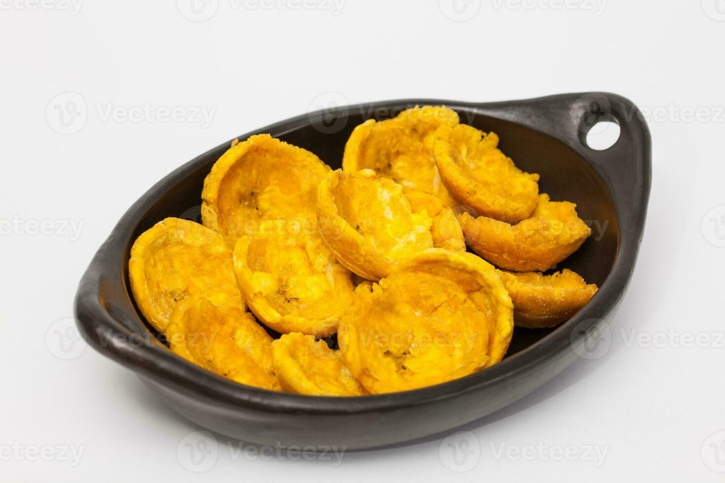 Plantain cups on traditional black ceramic dish photo