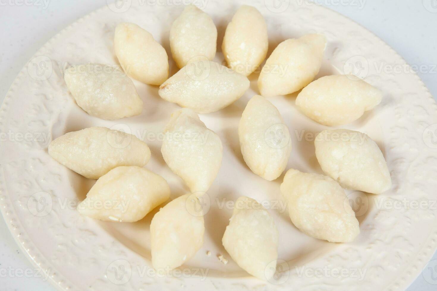 Preparation of a traditional Colombian fried  stuffed yucca dumplings called carimanolas photo