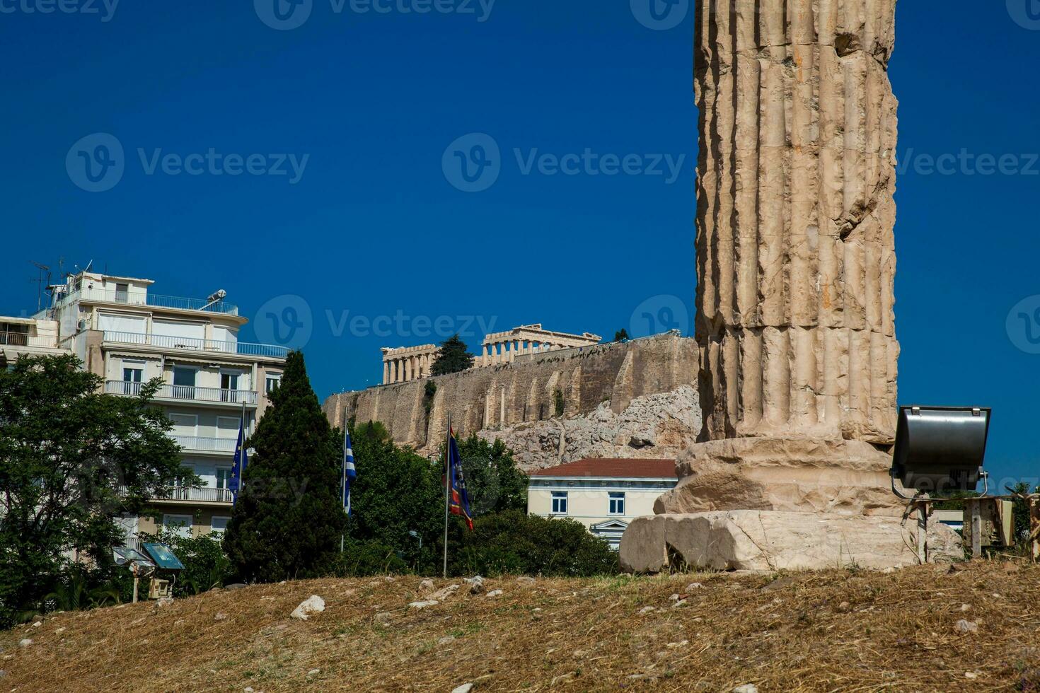 Ruins of the Temple of Olympian Zeus also known as the Olympieion and the Acropolis at the center of the Athens city in Greece photo