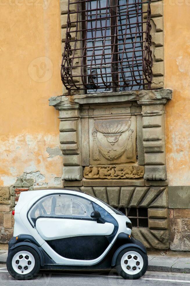 Electric car parked at the beautiful streets of Pisa photo