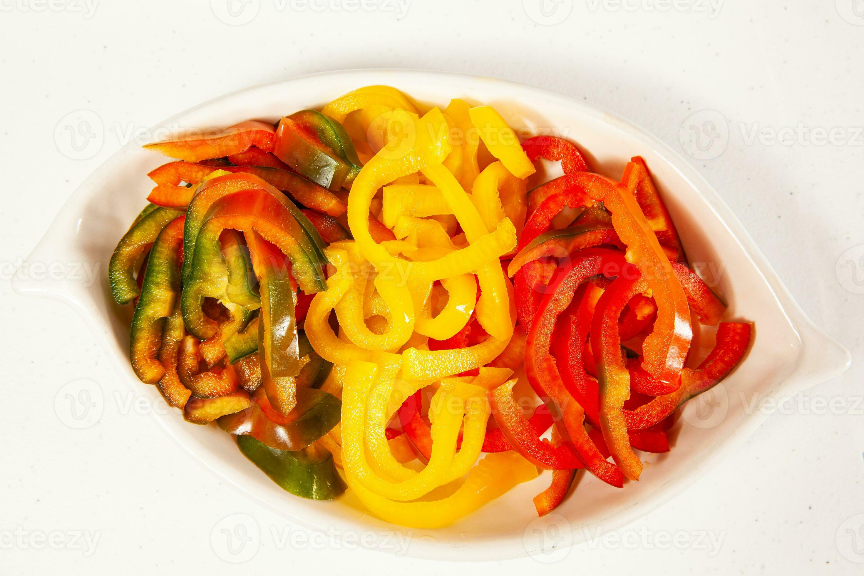 Fish marinade preparation steps. Red, green and yellow pepper cut in