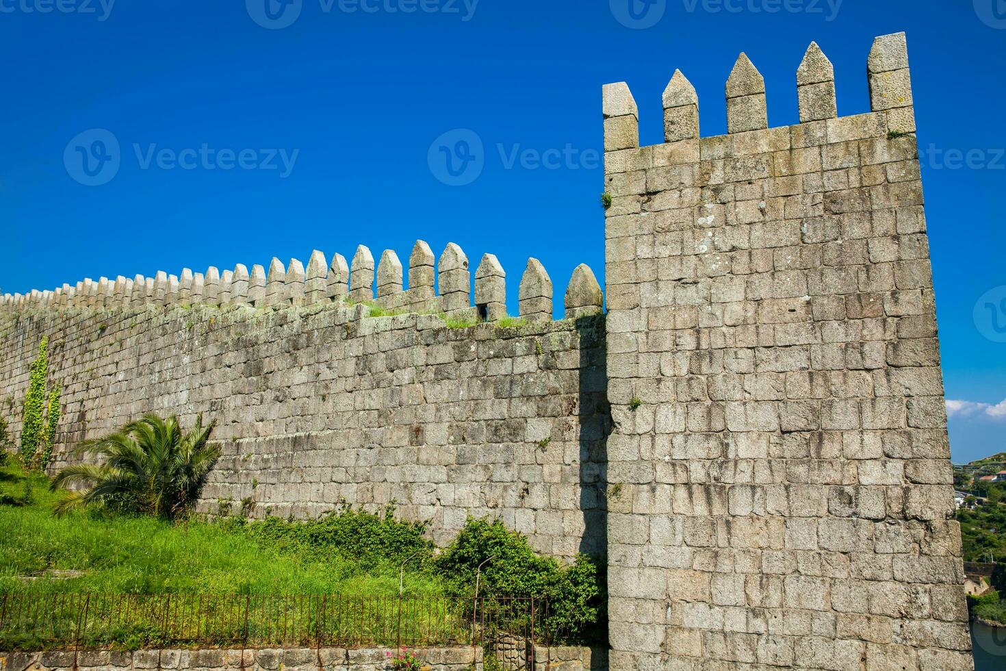 Detail of the Fernandine Walls of Porto located next to the Dom Luis I Bridge in a beautiful sunny day photo