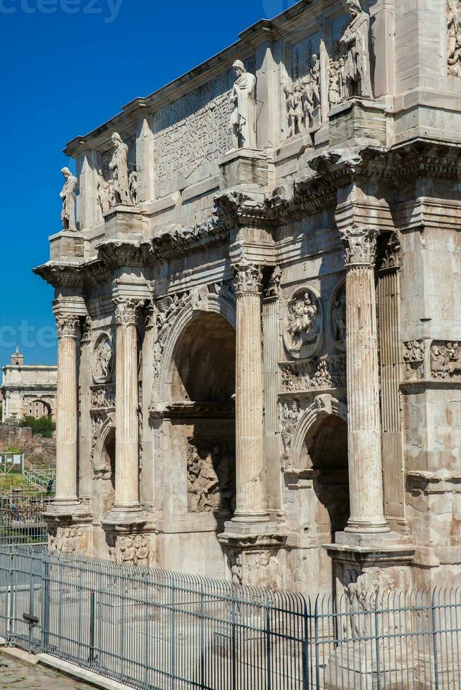 The Arch of Constantine a triumphal arch in Rome, situated between the Colosseum and the Palatine Hill built on the year 315 AD photo