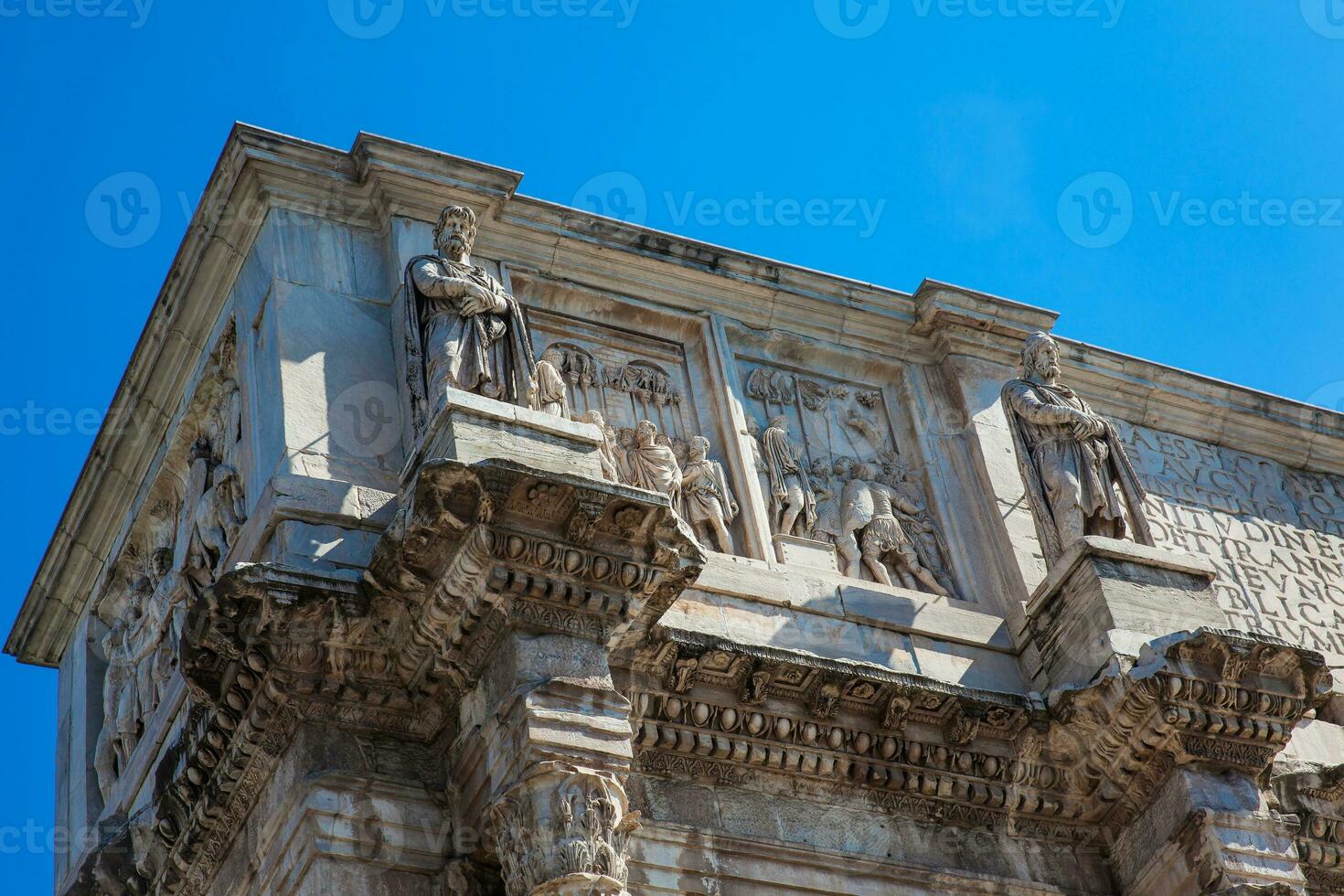 The Arch of Constantine a triumphal arch in Rome, situated between the Colosseum and the Palatine Hill built on the year 315 AD photo