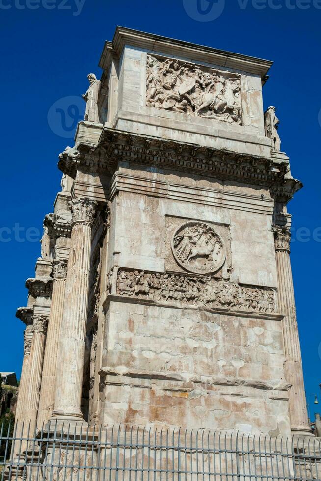 The Arch of Constantine a triumphal arch in Rome, situated between the Colosseum and the Palatine Hill built on the year 315 AD photo