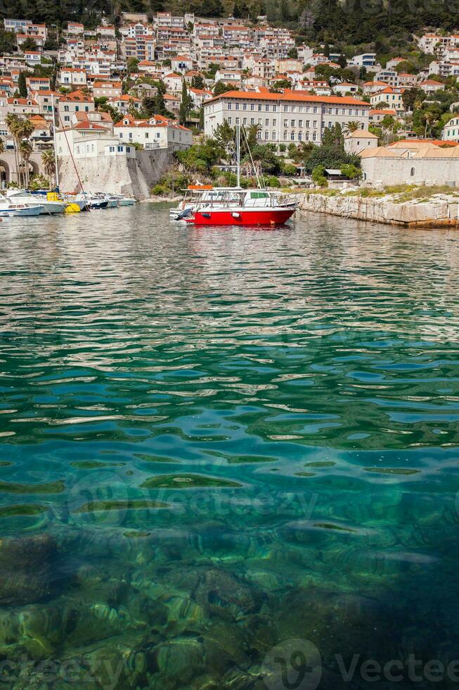 Red boat at Dubrovnik city old port marina photo