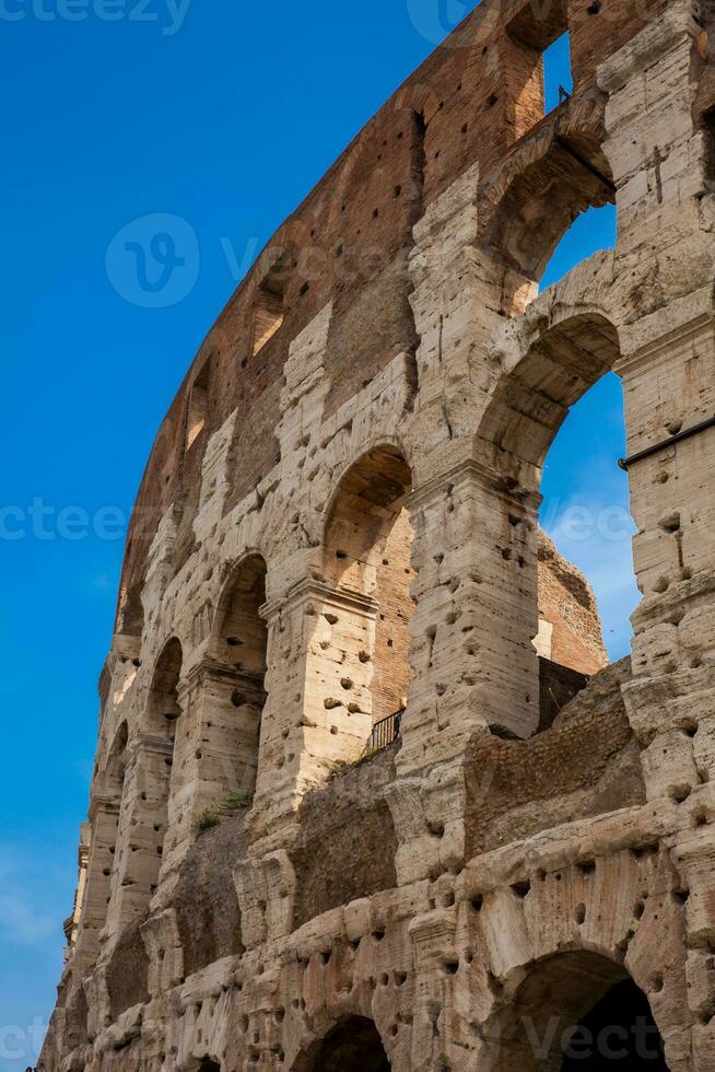 Detail of the  facade of the famous Colosseum or Coliseum also known as the Flavian Amphitheatre in the centre of the city of Rome photo