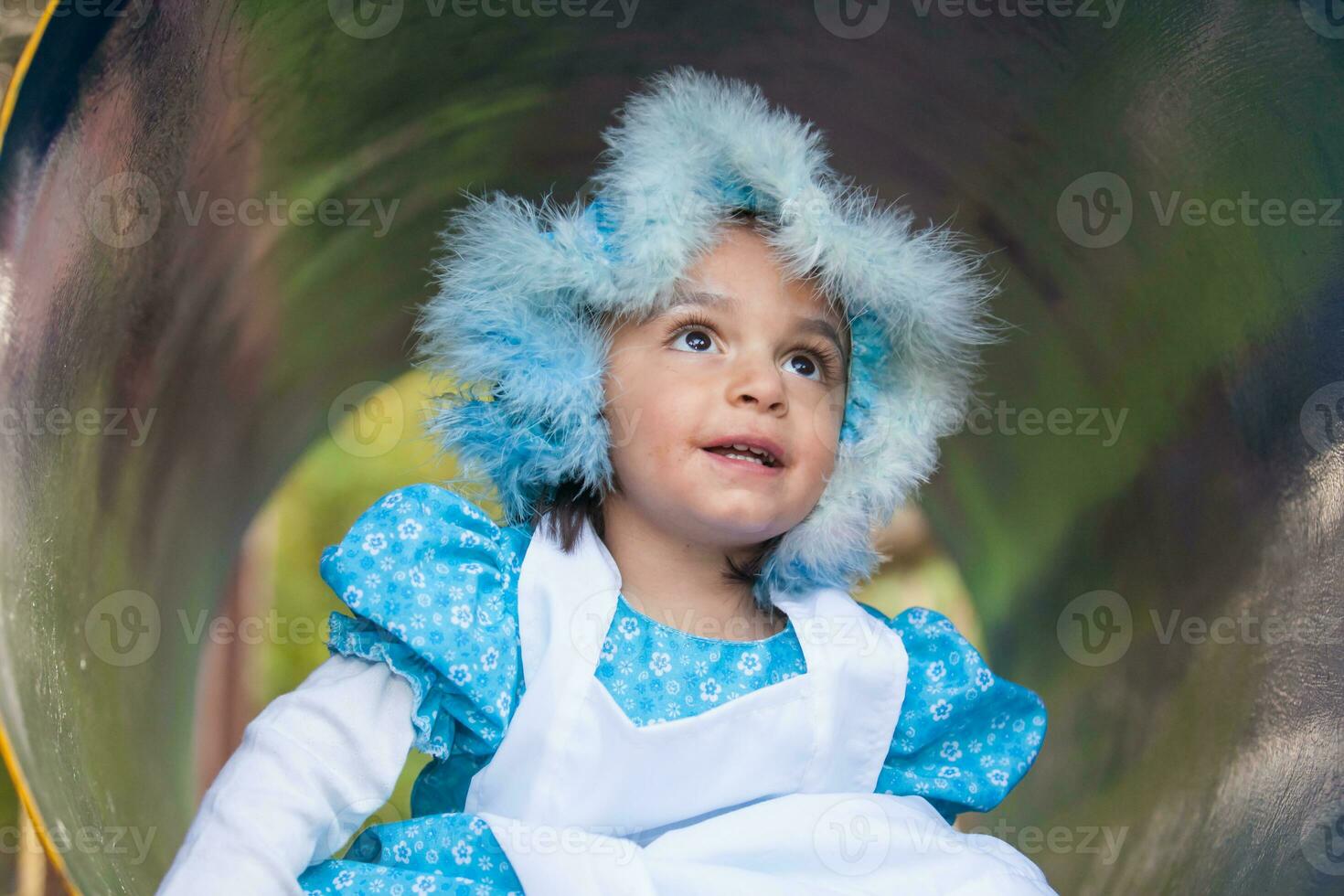 Little girl on grandma costume. Real family having fun while using costumes of the Little red riding hood tale in Halloween. photo