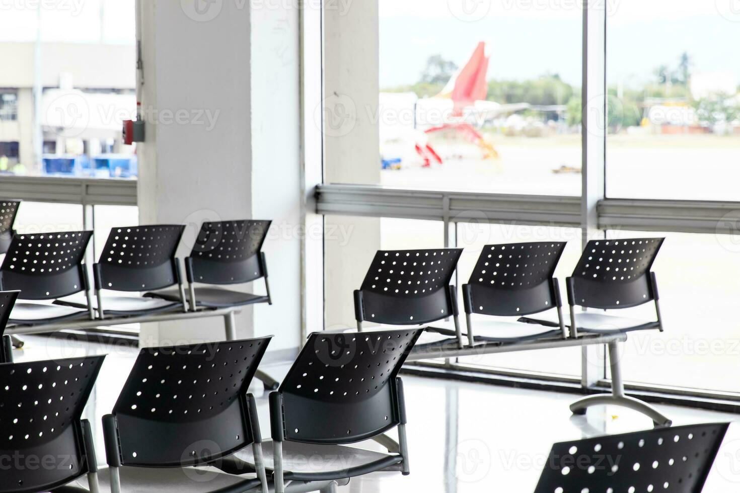 Empty wating room at an airport during COVID 19 pandemic with social distancing signs on chairs photo