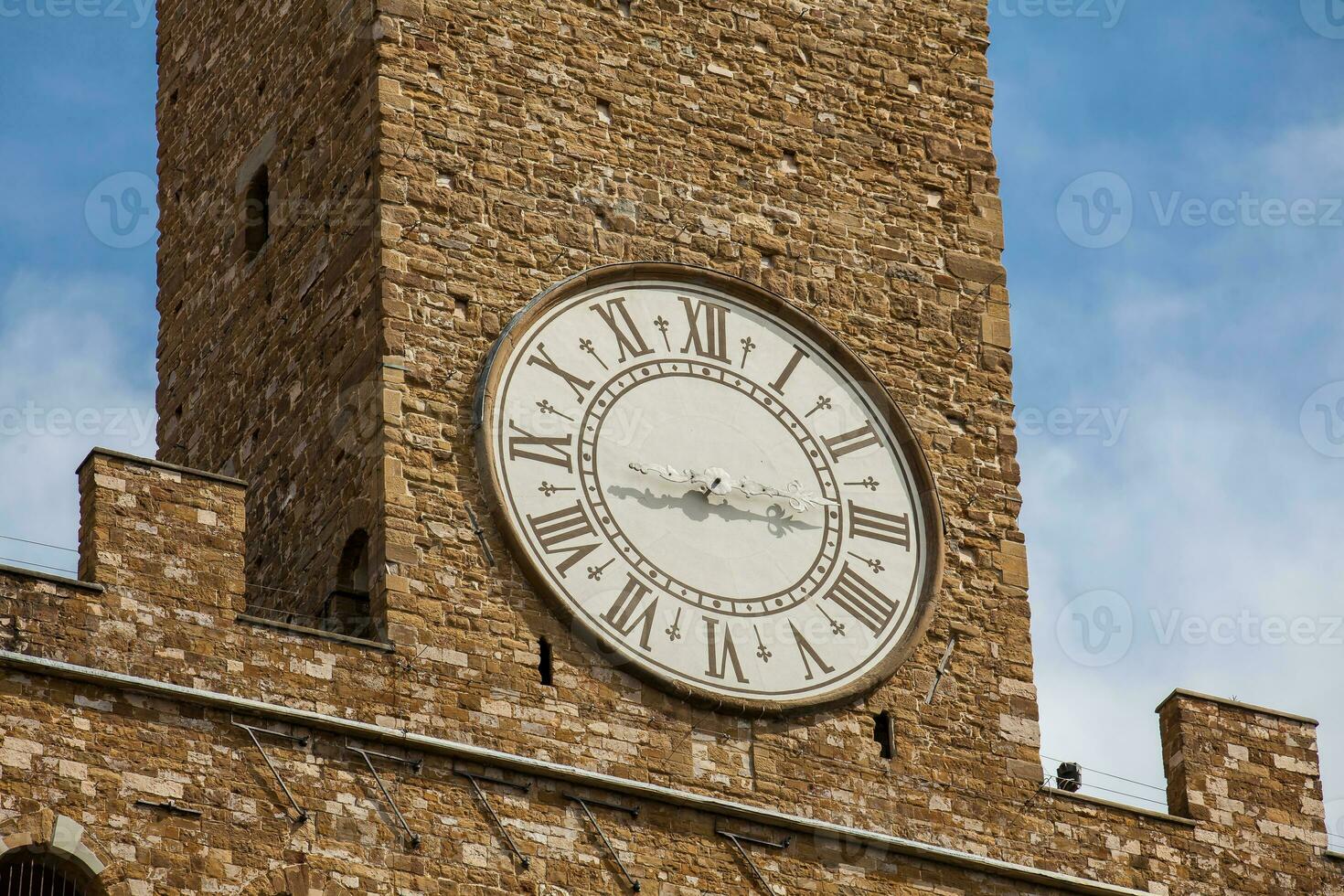 Clock tower of the Palazzo Vecchio built at the Piazza della Signoria in the 12th century in Florence photo