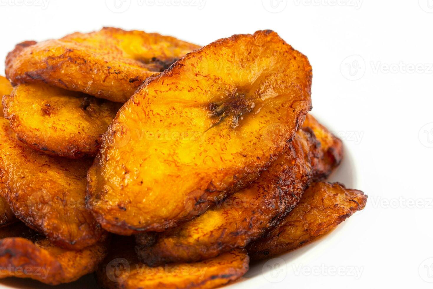 Deep fried ripe plantain slices isolated in white background photo