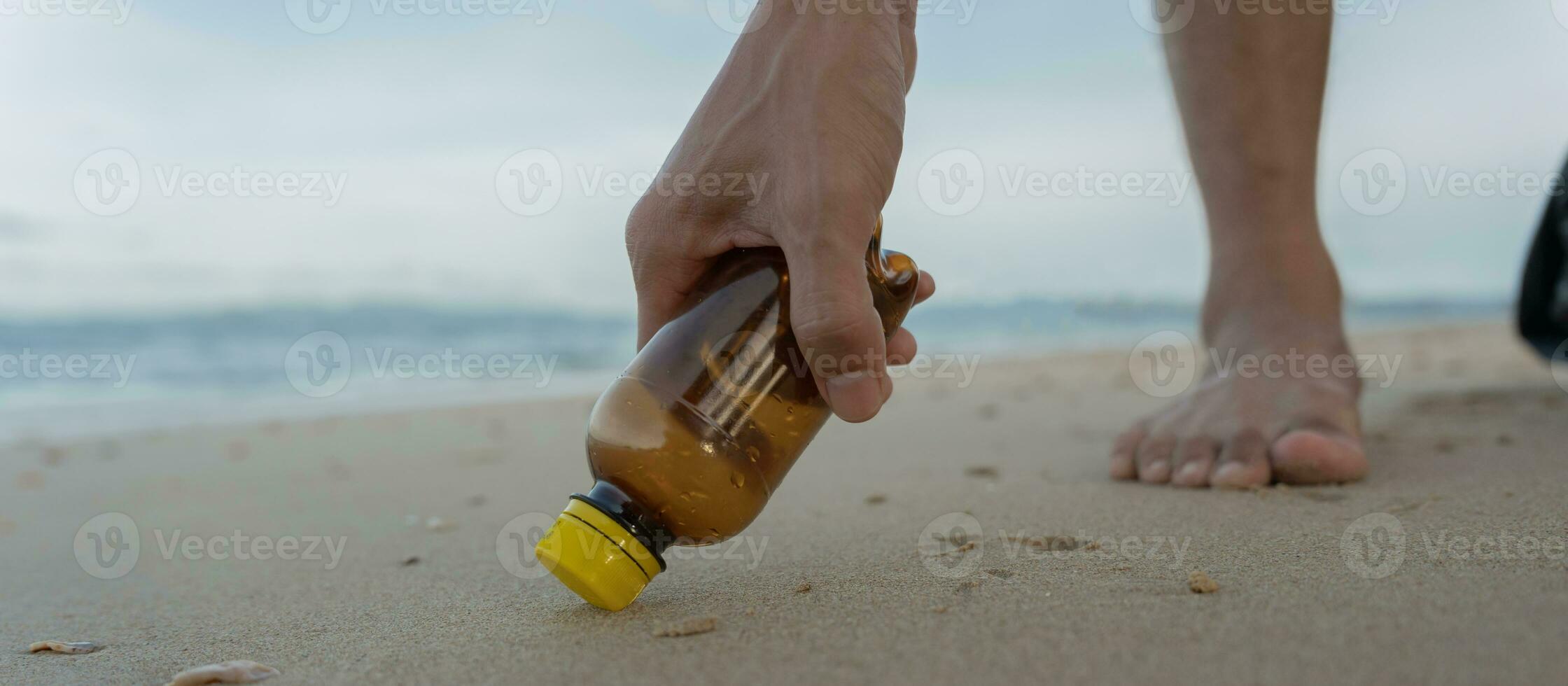 Save water. Volunteer pick up trash garbage at the beach and plastic bottles are difficult decompose prevent harm aquatic life. Earth, Environment, Greening planet, reduce global warming, Save world photo