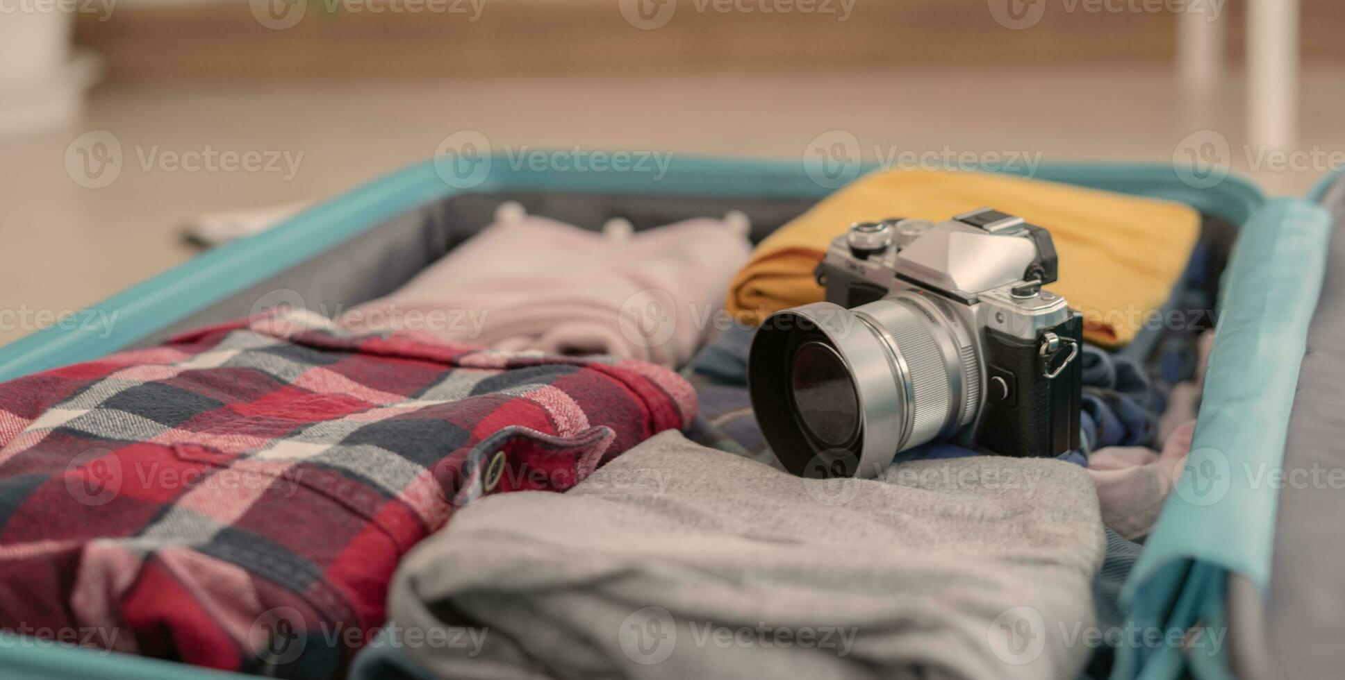 Traveler. preparing a camera for travel and photography. women are prepare clothes and personal belongings. Pack your luggage before travel. holiday, vacation time, long weekend, summer photo