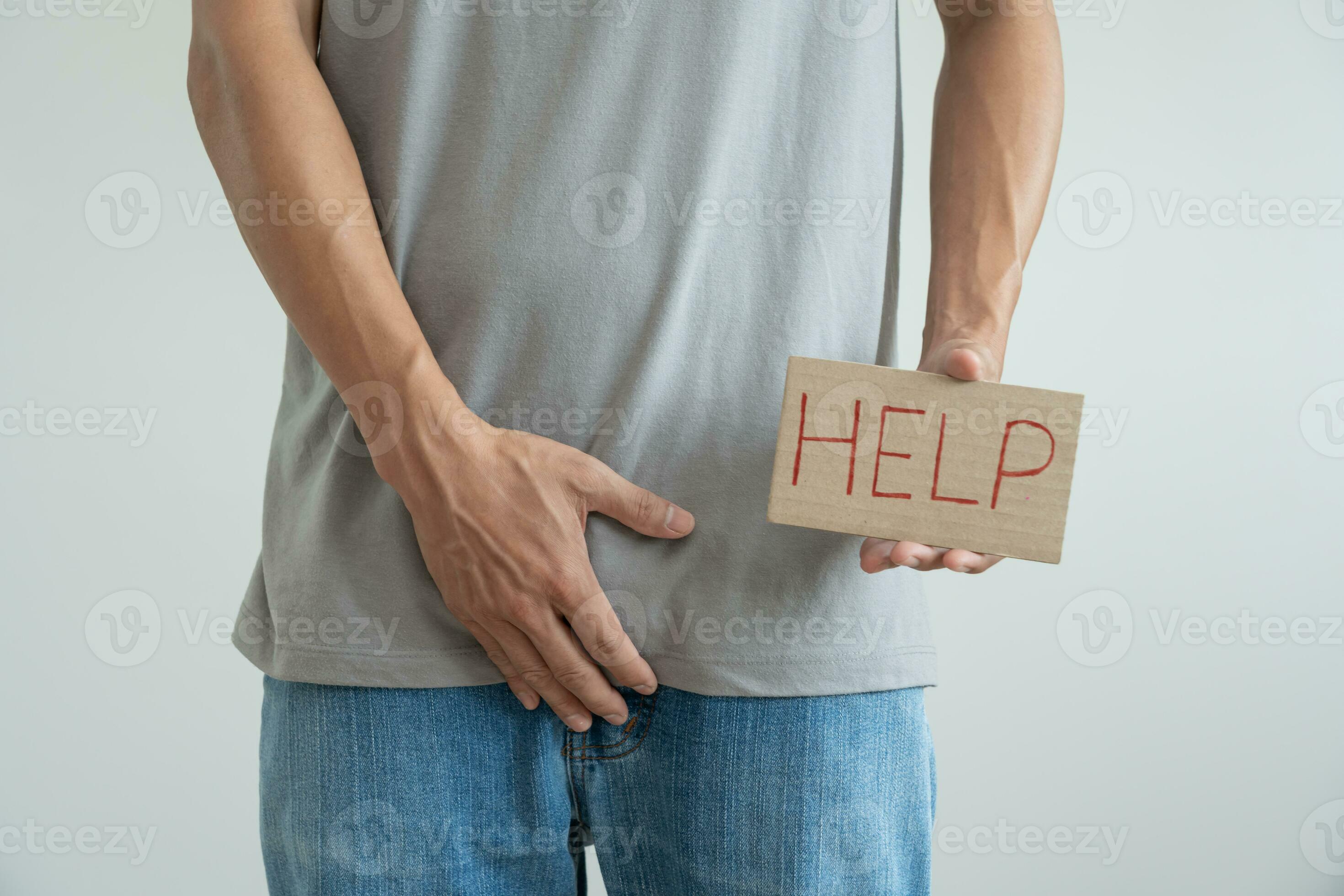 Man hold hand in front of private parts feeling from disease