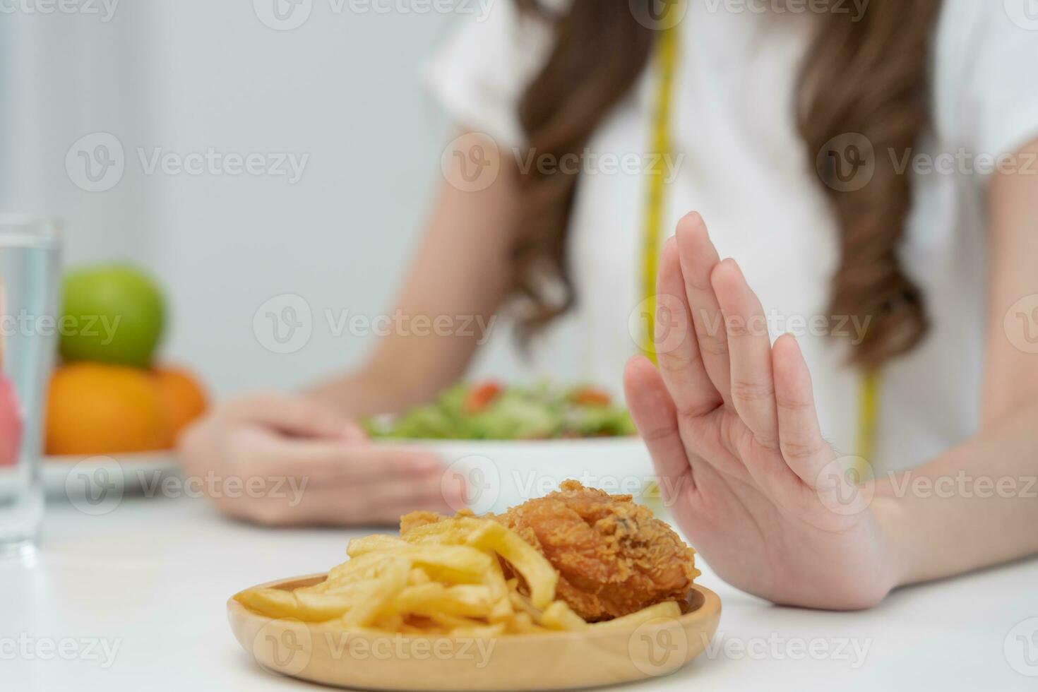 Beauty slim female body confuse fat food. Woman in restaurant achieves weight loss goal for healthy life, low calorie, thin waist, nutritionist. Diet, body shape, balance control, avoid, nutritional photo