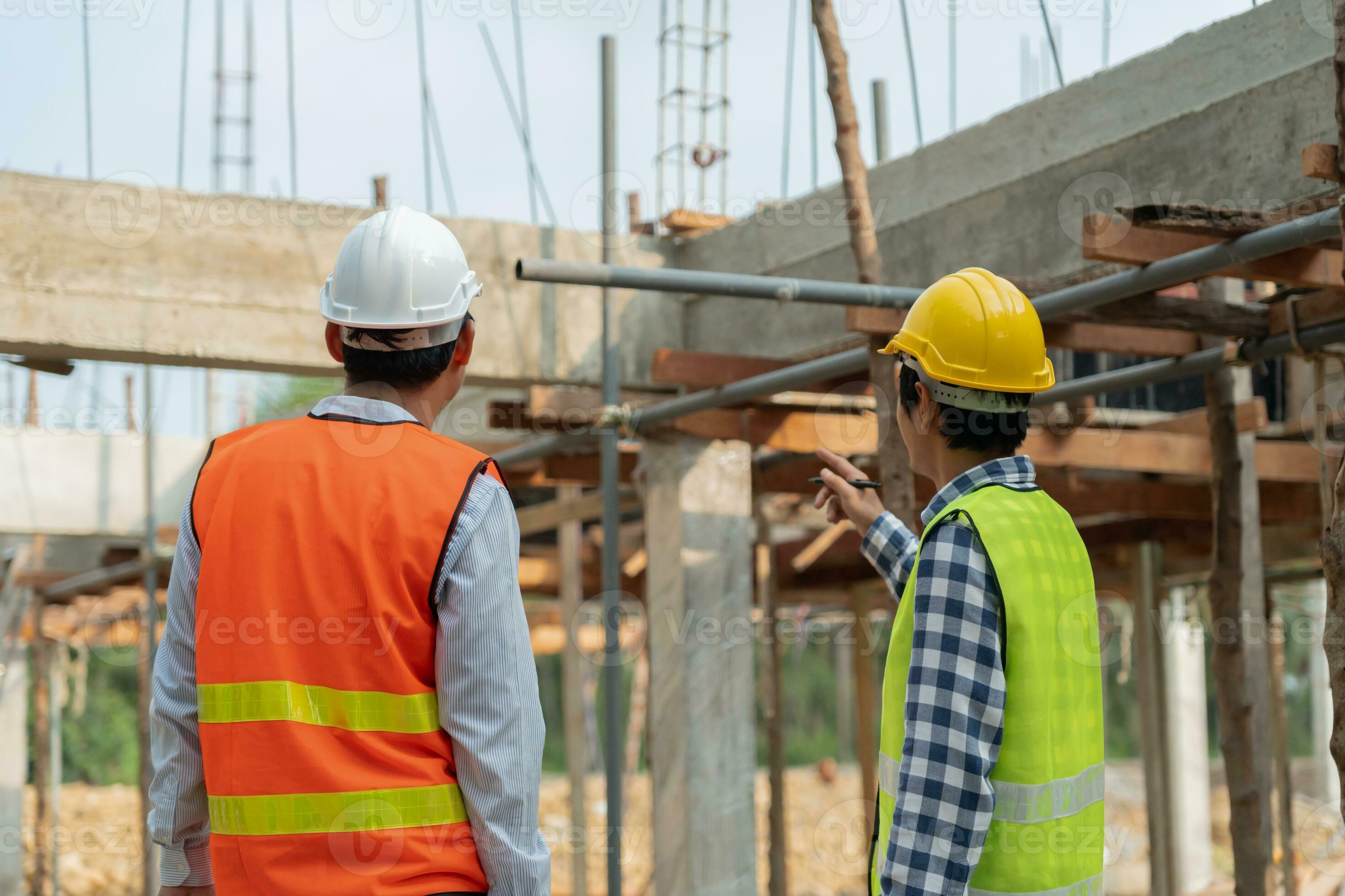 Engineers use blueprint check construction on site. Contractor and