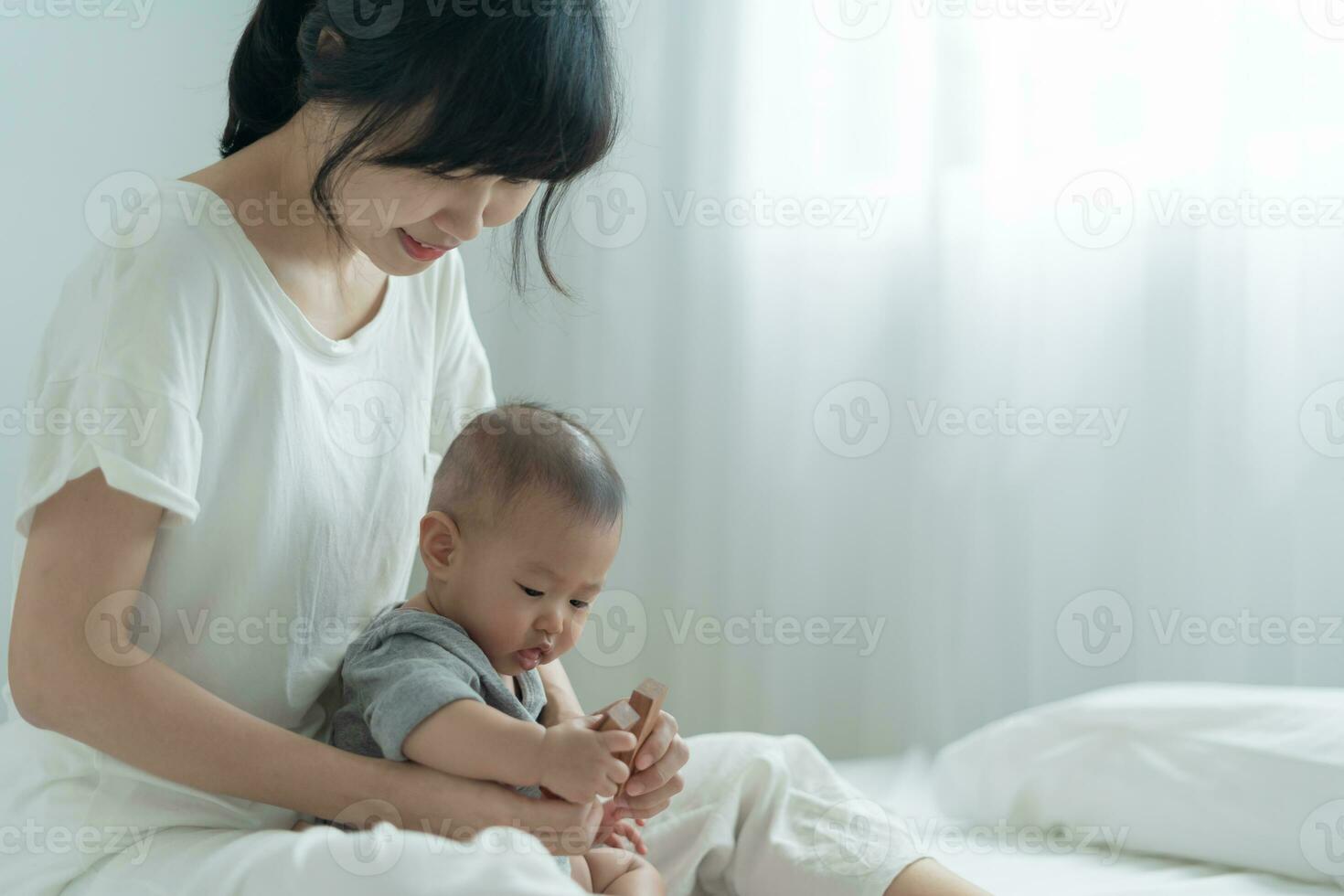 Happy Asia mother play and learn toy blocks with the little baby. Funny family is happy and excited in the house. Mother and daughter having fun spending time together. Holiday, Activity, development photo
