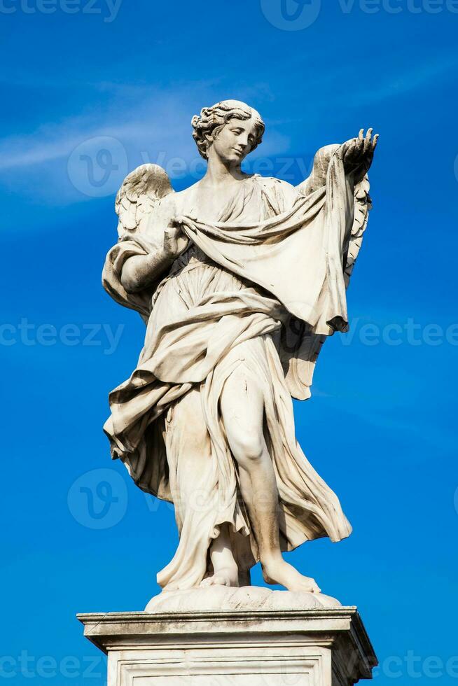 Beautiful Angel with the Sudarium statue created by Cosimo Fancelli on the 16th century at Sant Angelo Bridge in Rome photo