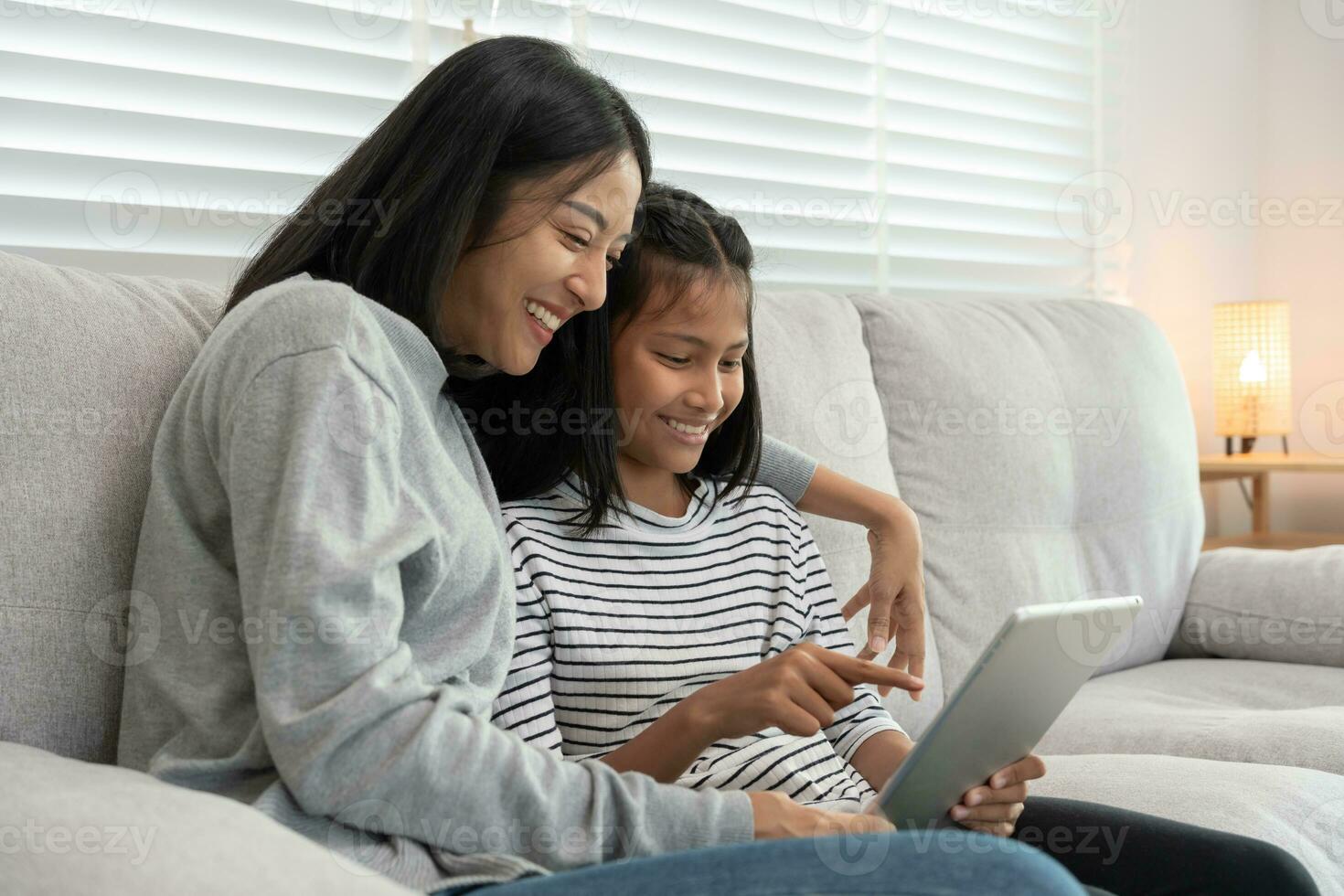 Technology searching on new education by use tablet at home. play back online course, girl student use internet to study, notes homework, world wide. online tutor online course for Asian children. photo