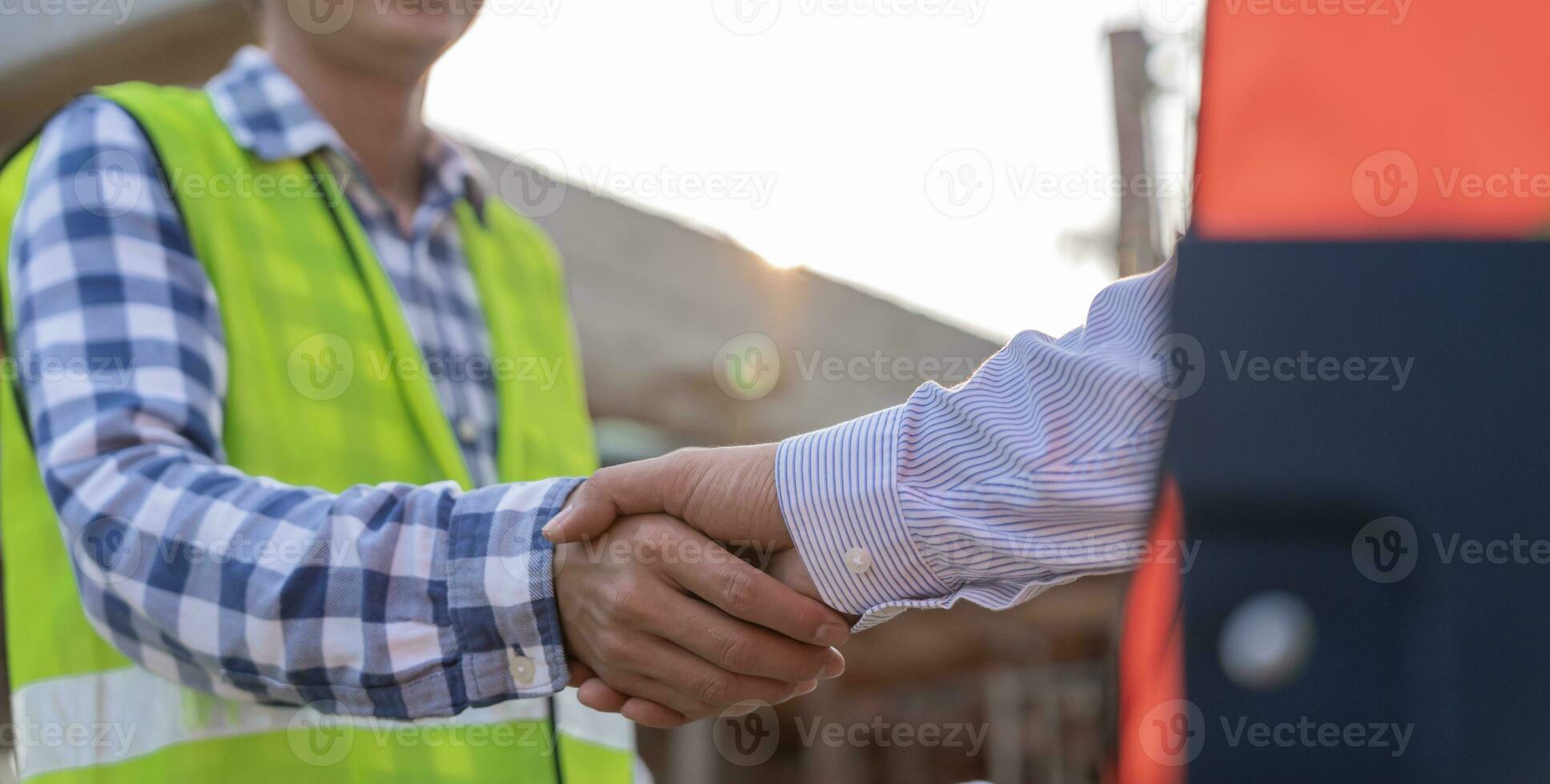 Construction worker team hands shaking greeting start up plan new project contract in office center at construction site, industry ,architecture, partner, teamwork, agreement, property, contacts. photo
