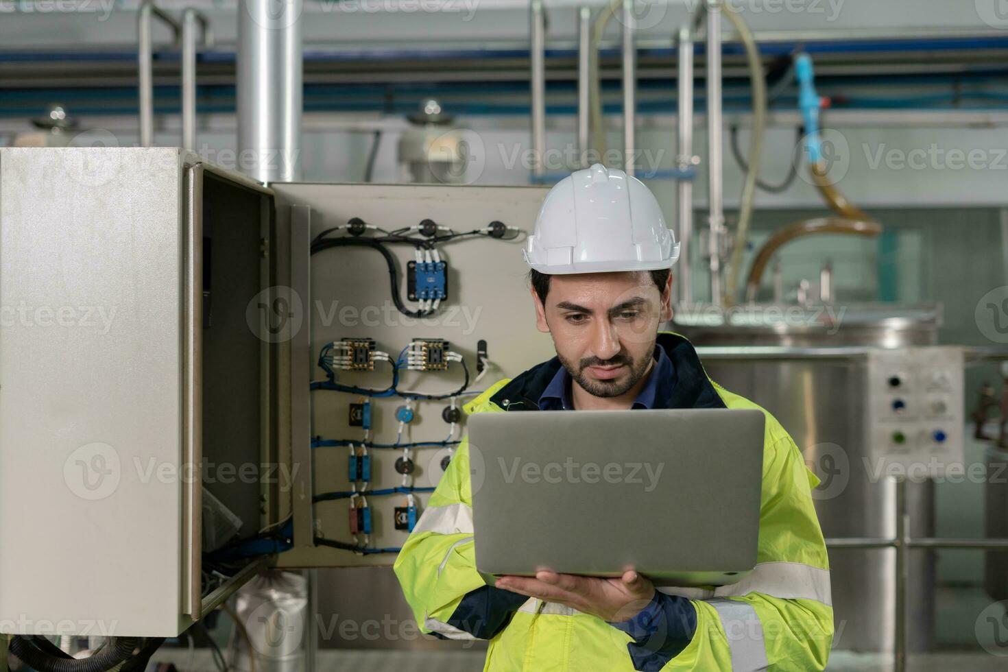 Mechanic or maintenance or electrical engineer checking main electrical control systems industrial plant. Utility fore man daily check power systems in process. Main Distribution Board, Switchboards photo