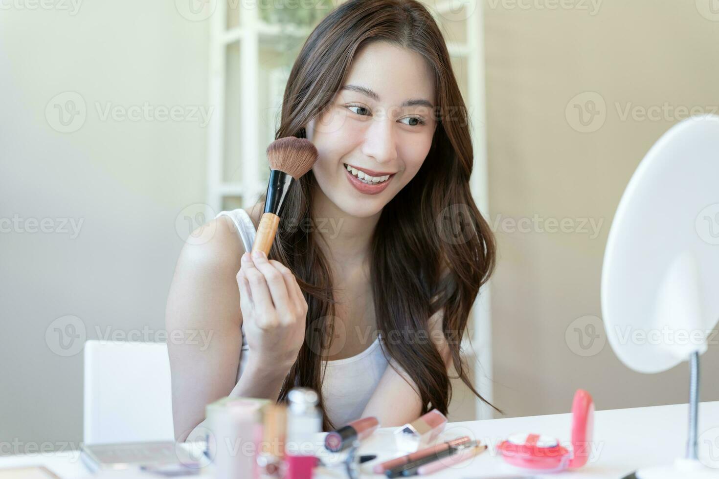 Beautiful Asian woman sit in front of a mirror. face of a healthy woman applying makeup. Advertisement for skin care, anti-wrinkle, baby face, whitening, moisturizer, tighten pores serum photo