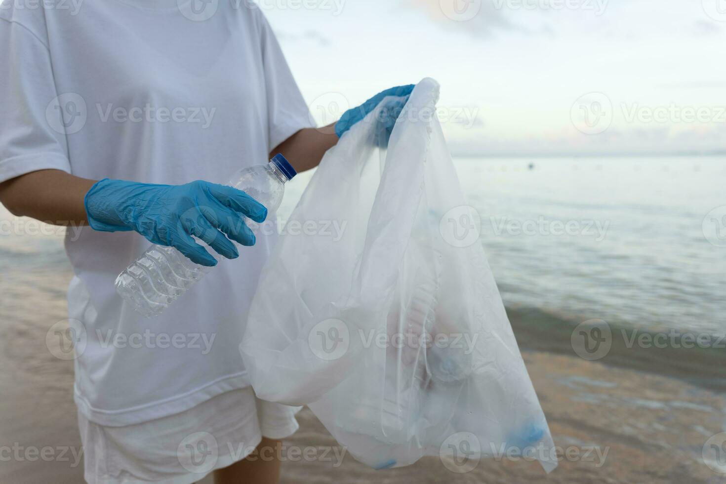 Save ocean. Volunteer pick up trash garbage at the beach and plastic bottles are difficult decompose prevent harm aquatic life. Earth, Environment, Greening planet, reduce global warming, Save world photo