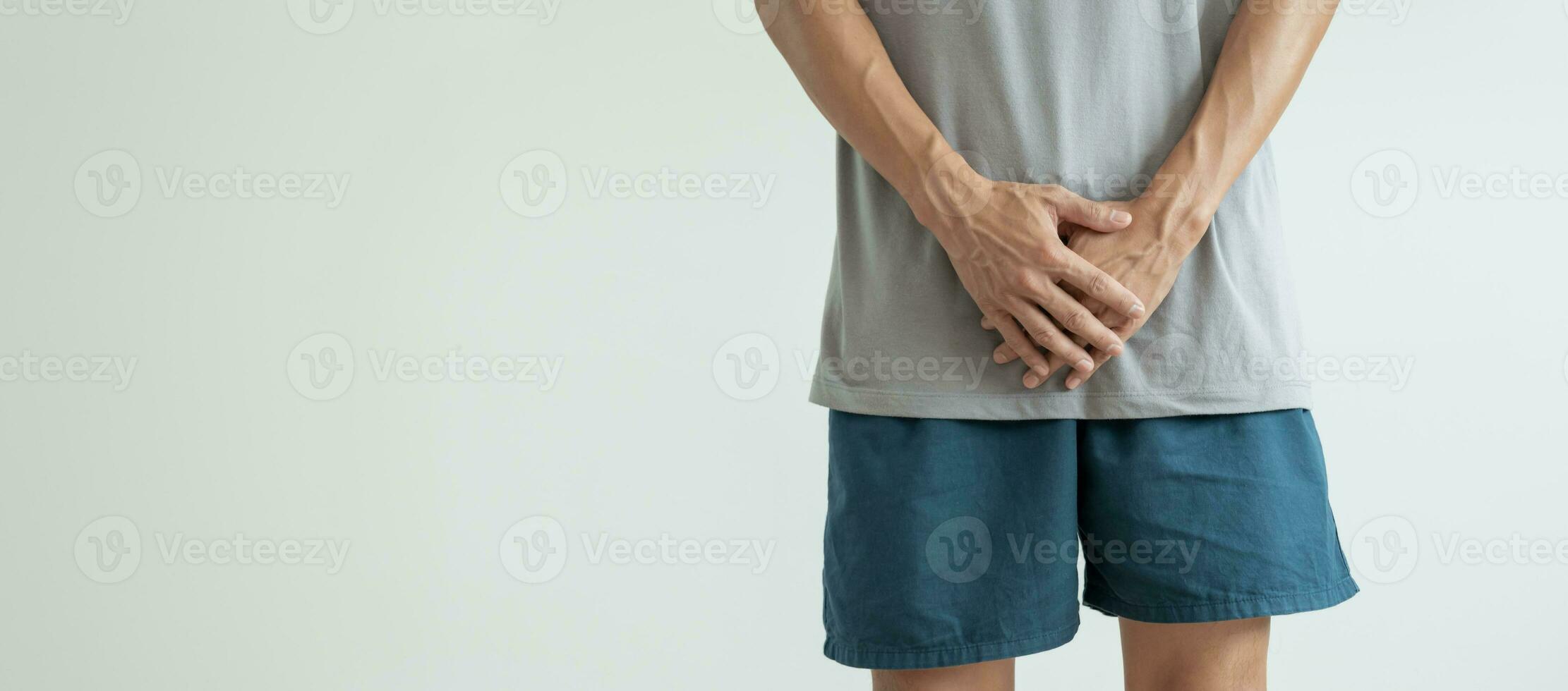 Man hold hand in front of private parts feeling discomfort from disease and inflammation. Venereal, testicular cancer. bladder problems, erectile dysfunction, premature ejaculation, prostate cancer photo